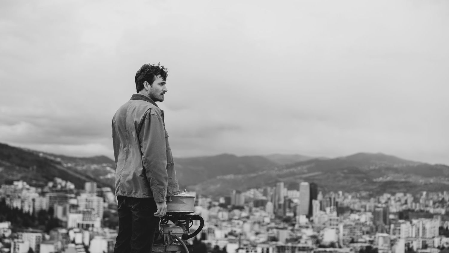 A black and white panoramic series of vintage cityscape photos showing mountain views and urban development.