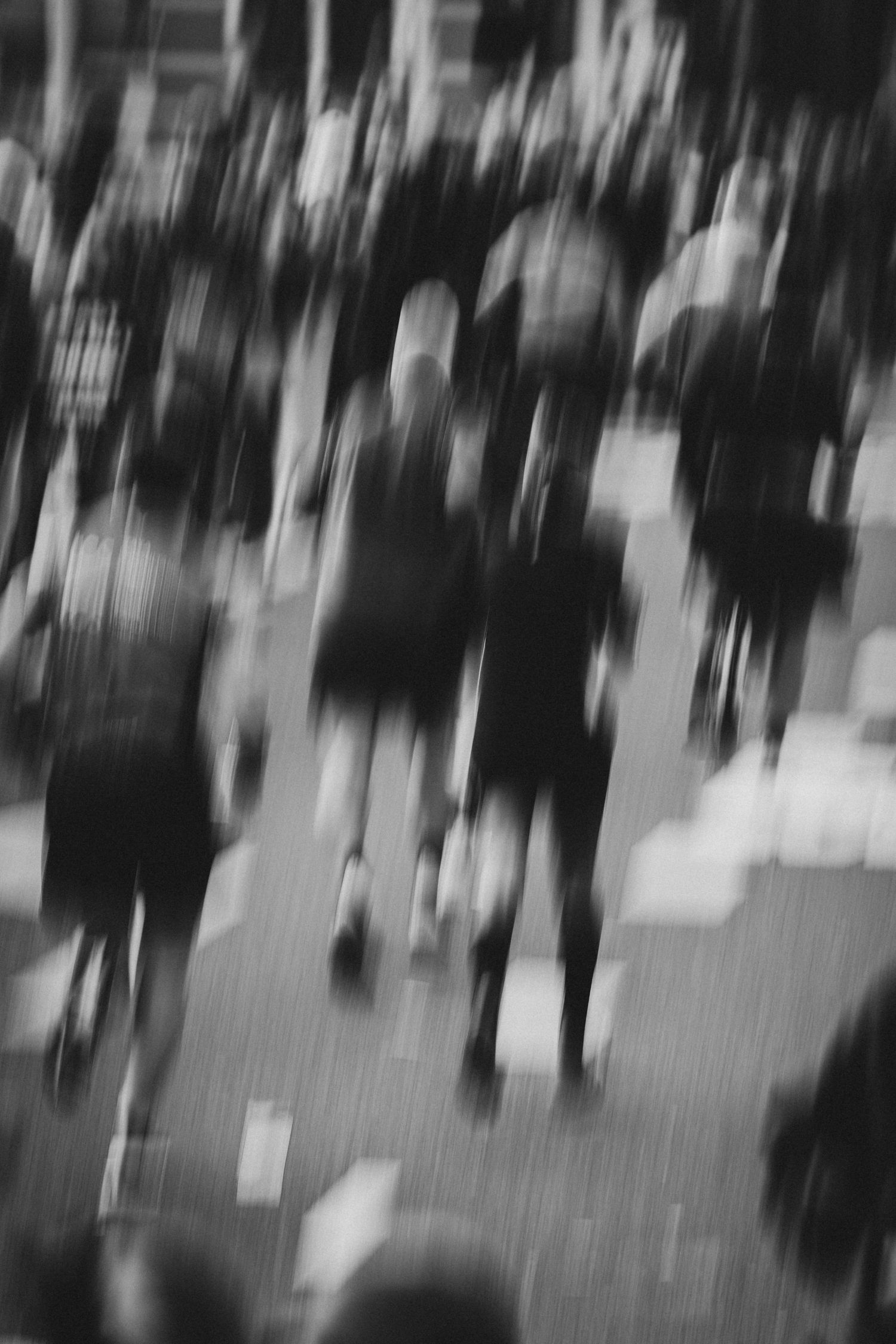 Abstract black and white motion blur of people walking.