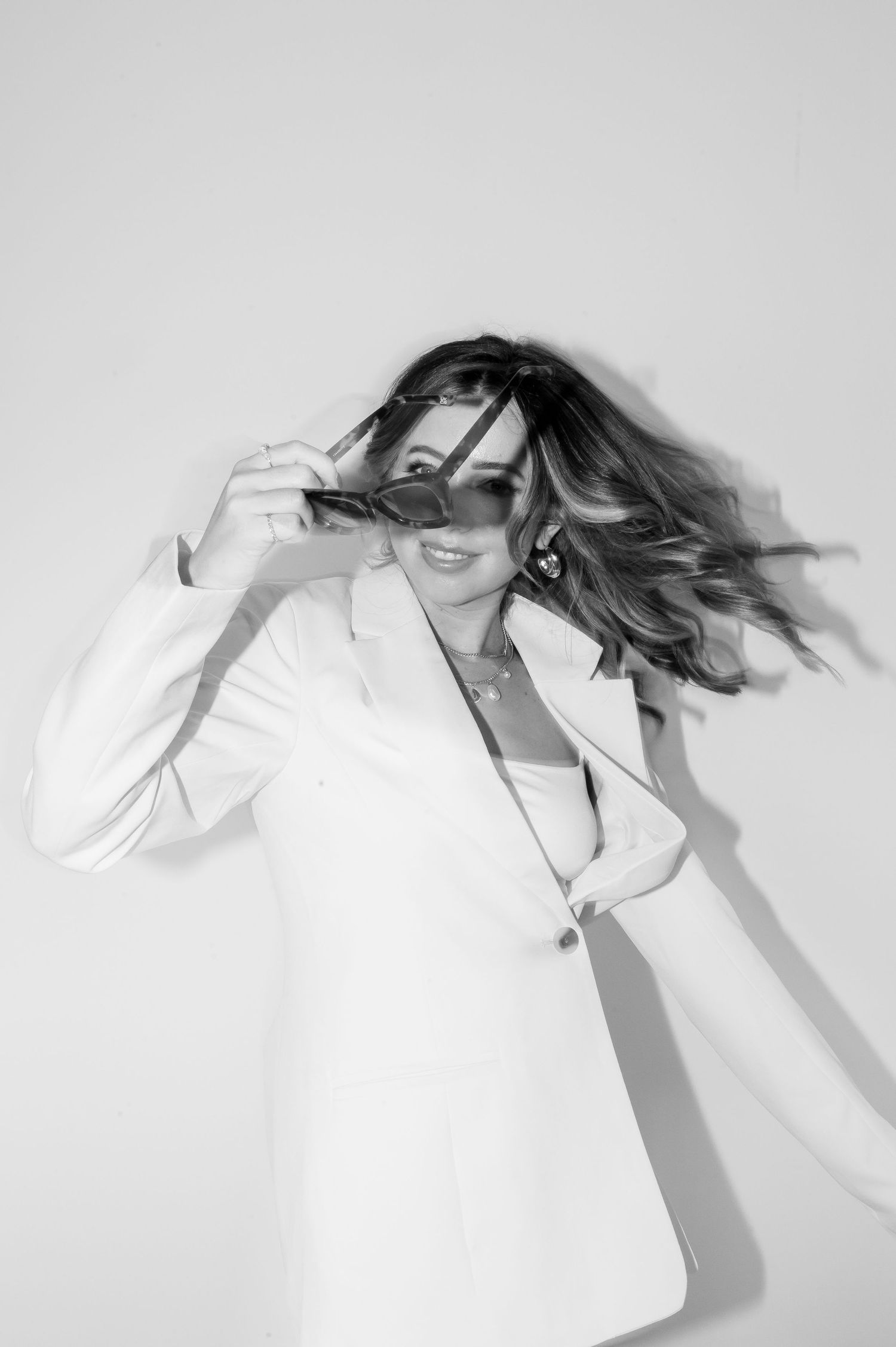 Artistic black and white motion shots showing flowing hair movement against light background.