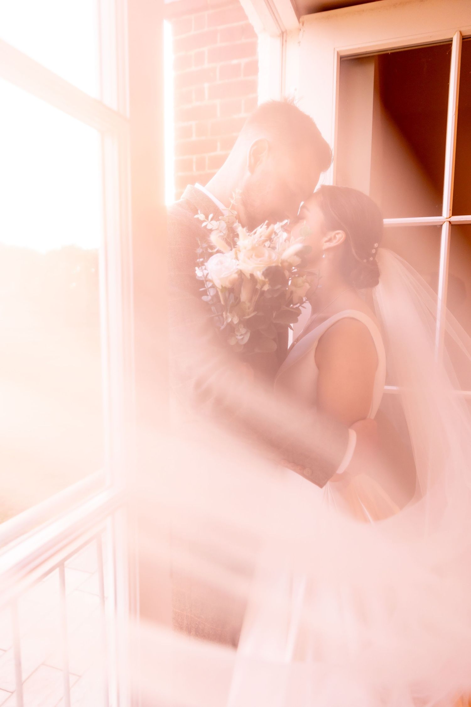 Soft pink tinted photo sequence showing blurred silhouettes and light rays through windows.
