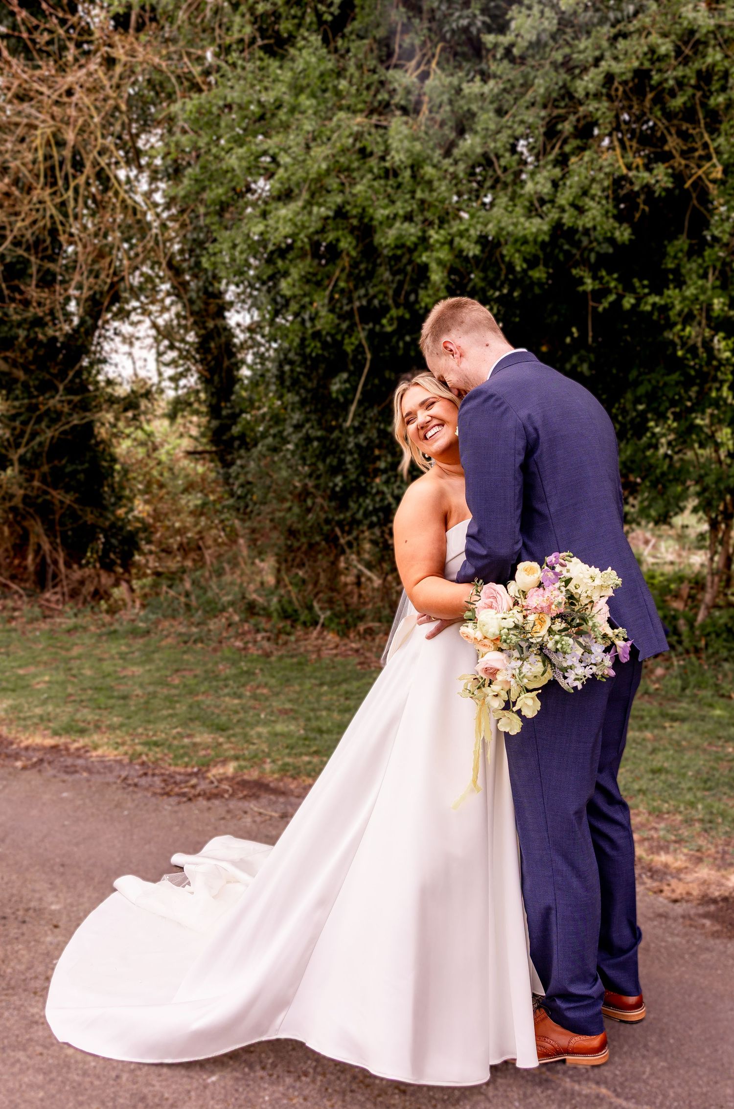Wedding couple shares intimate moments in an outdoor garden setting.