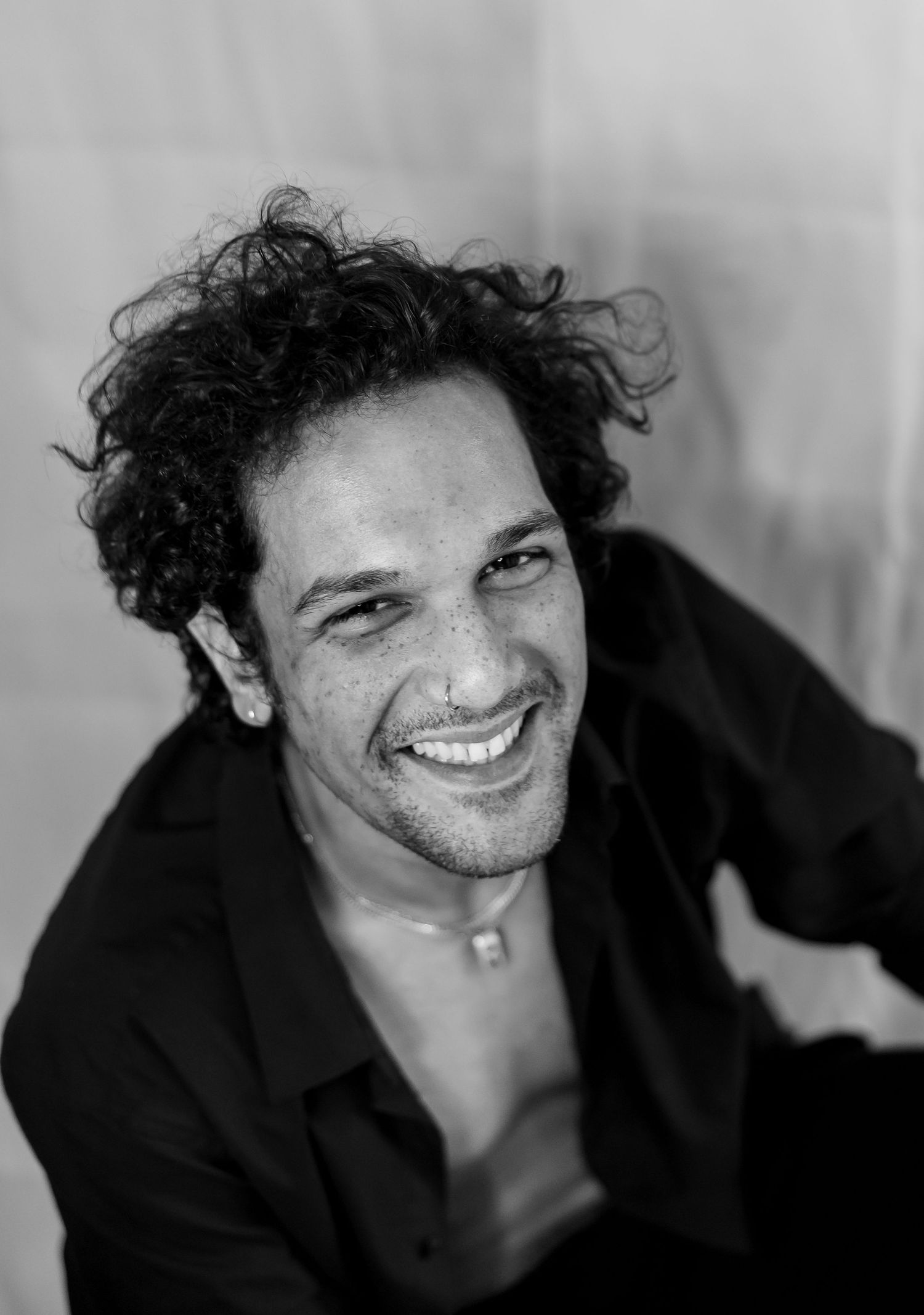Close-up black and white portraits capturing candid expressions and natural smiles.