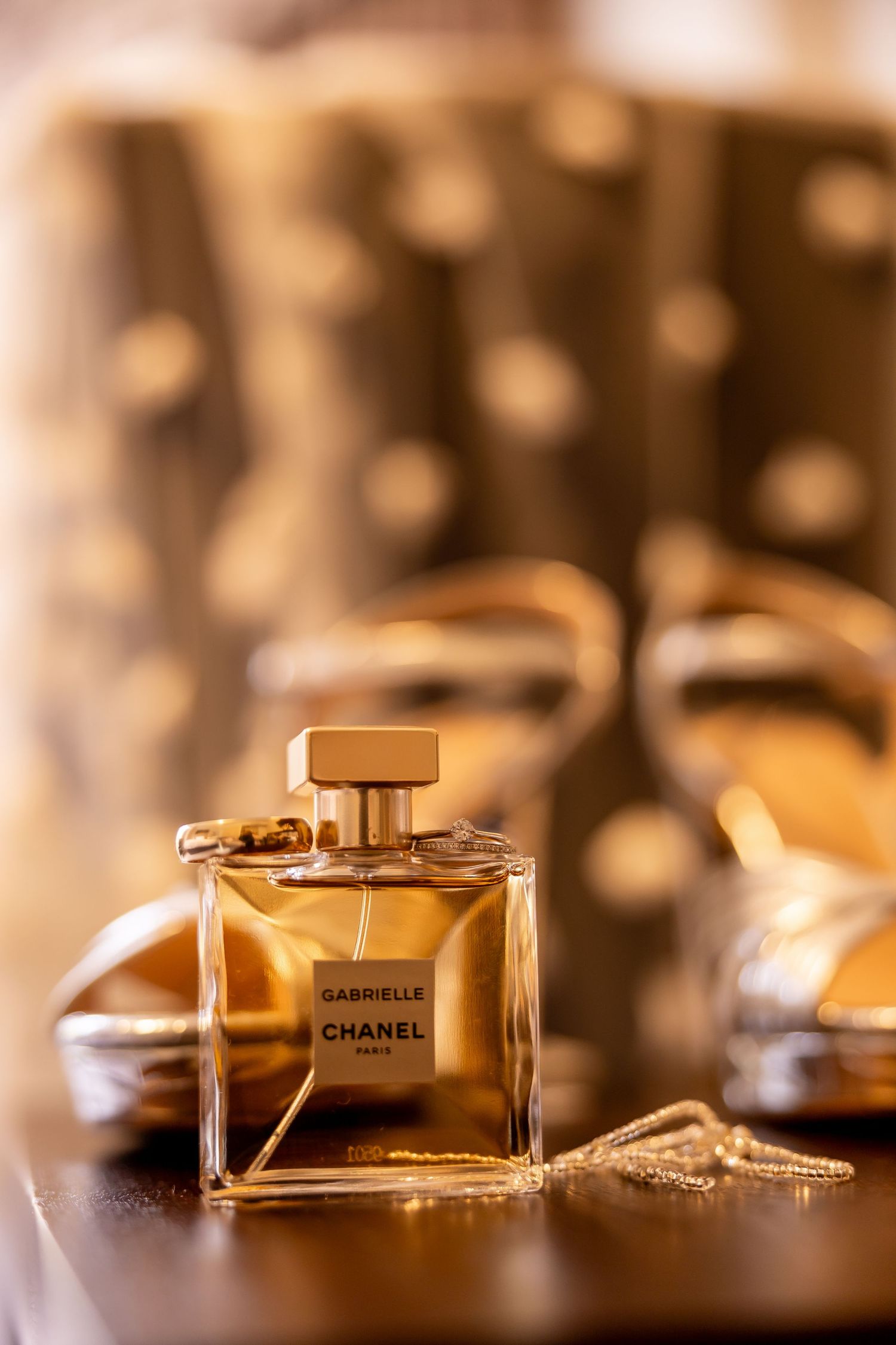 Luxury perfume bottles arranged artistically with golden bokeh lighting.