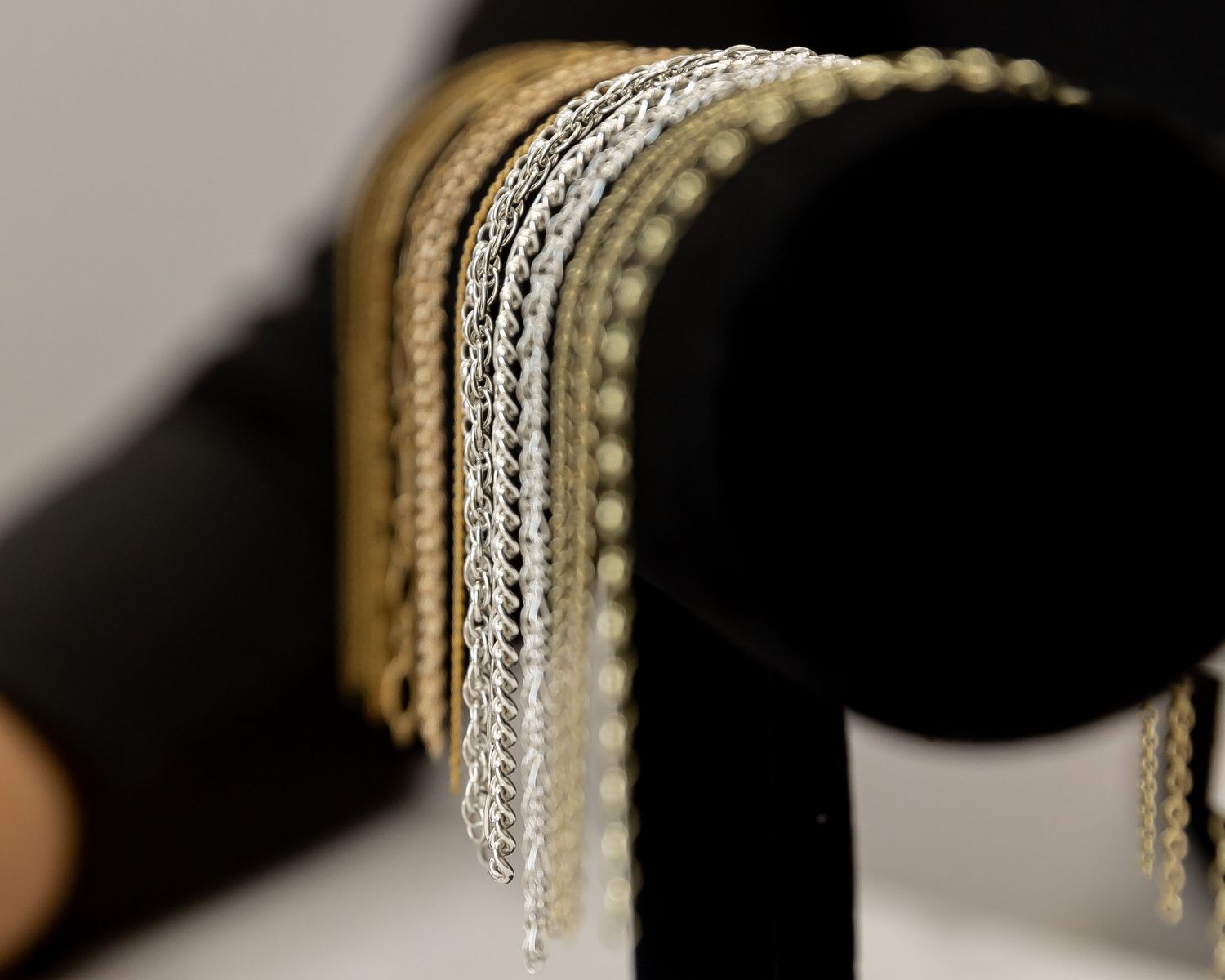 Abstract close-up of dangling crystal jewelry details against dark background.