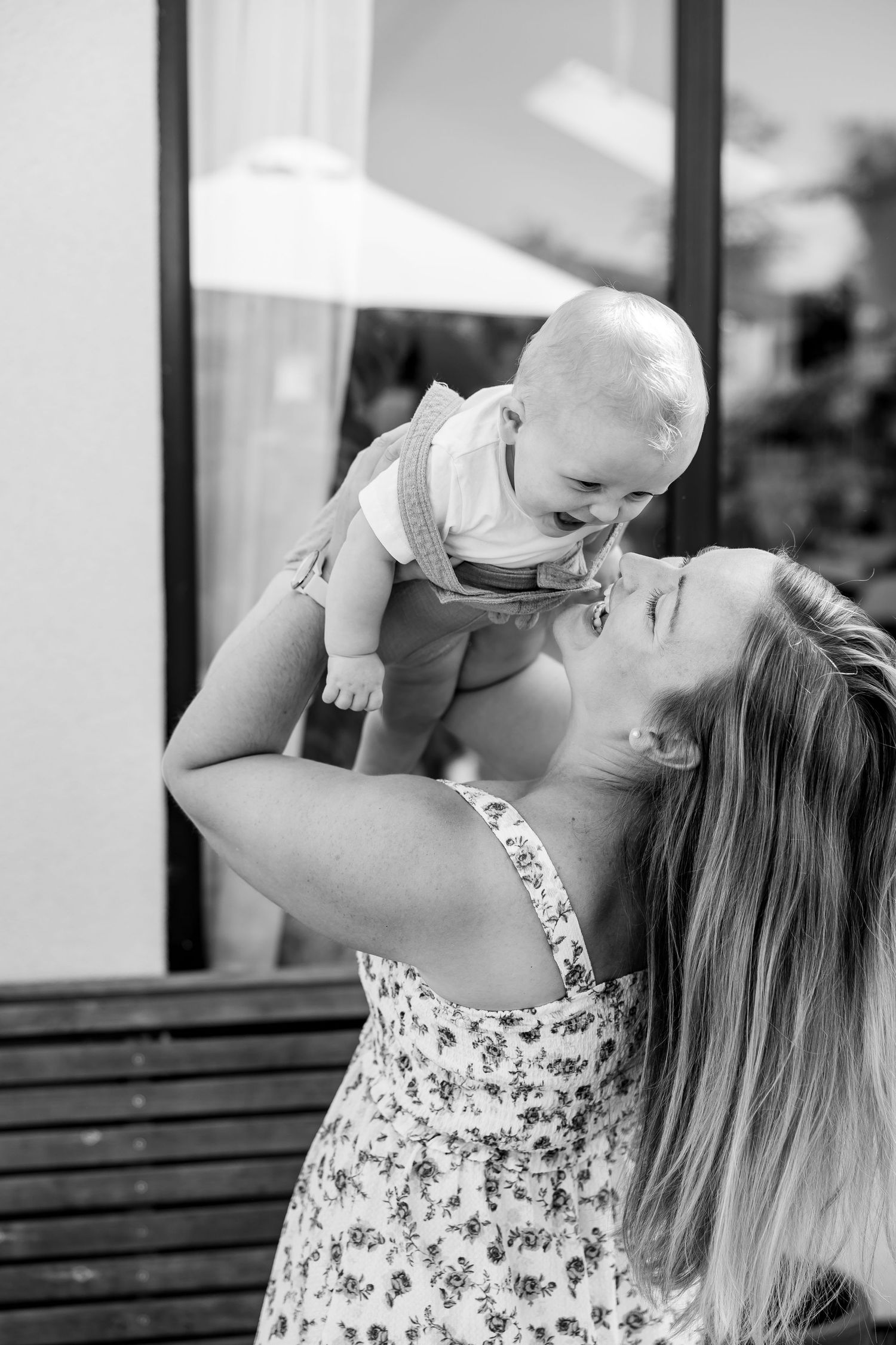 Sweet black and white sequence of intimate parent-child bonding moments on a bench.