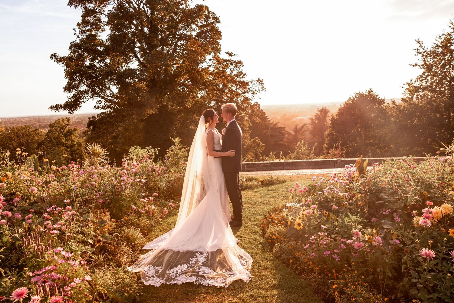 Dreamy sunset wedding photos captured in a rose garden with golden hour lighting.