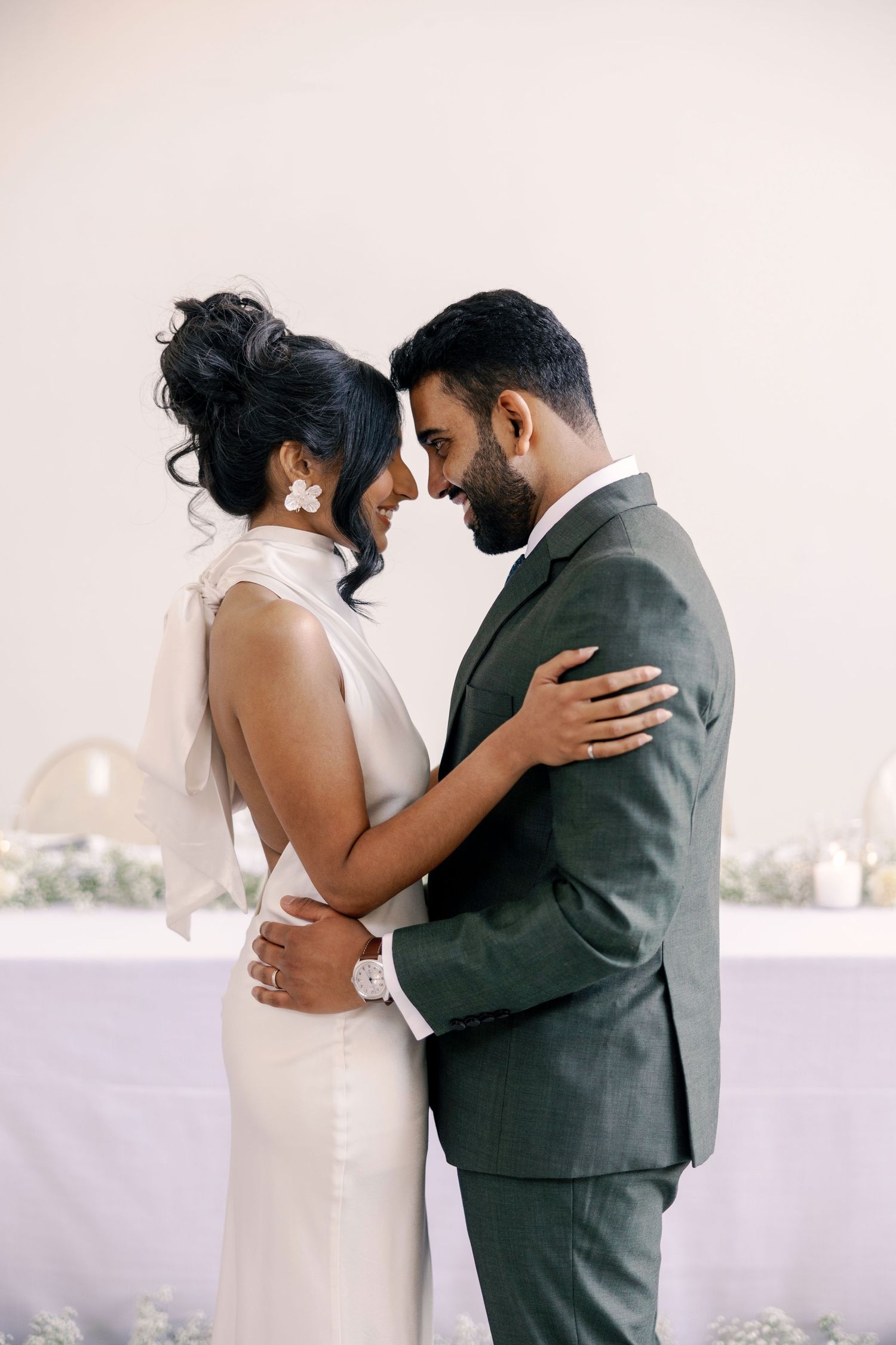 A series of intimate wedding portraits captured against a clean white backdrop.