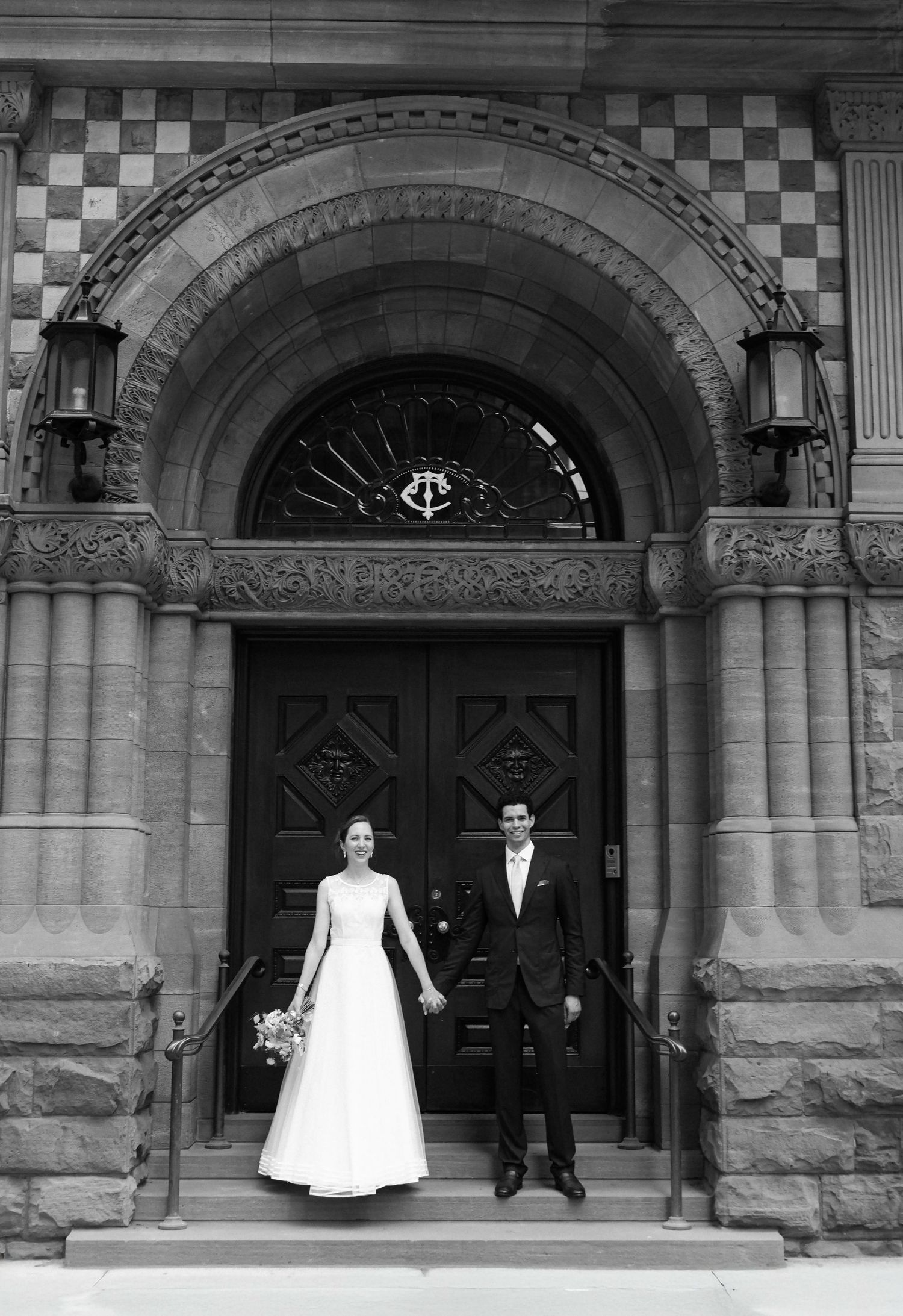 A black and white photo series showing a couple in formal wedding attire posing in front of ornate stone archways.