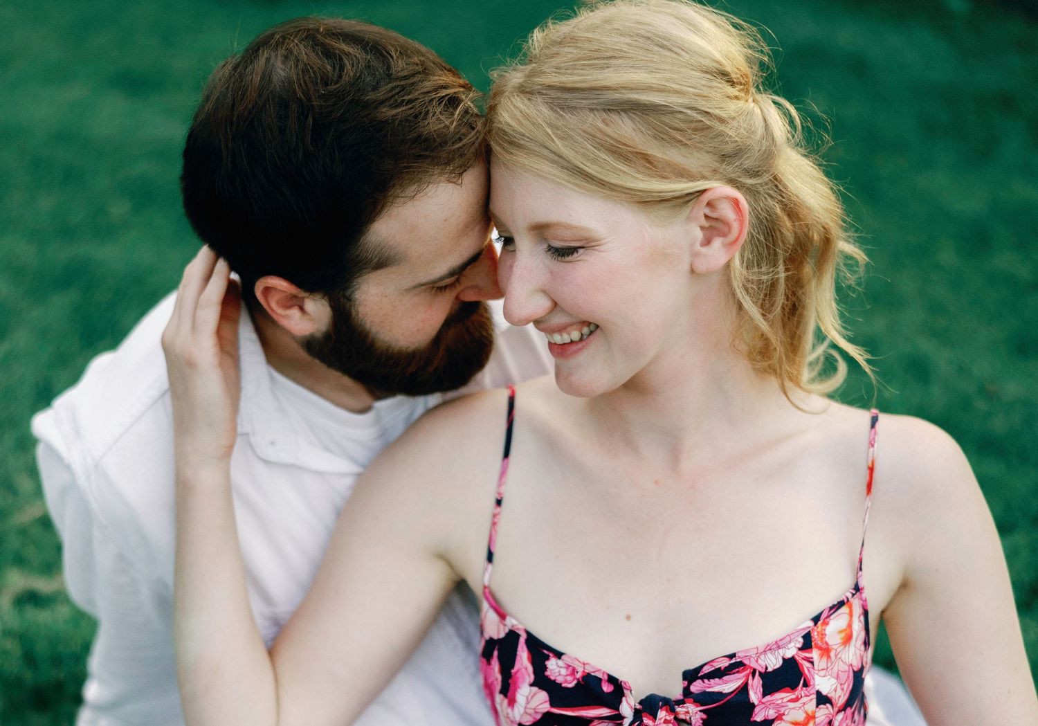 A romantic couple in a garden setting shares tender moments in a series of intimate portraits.