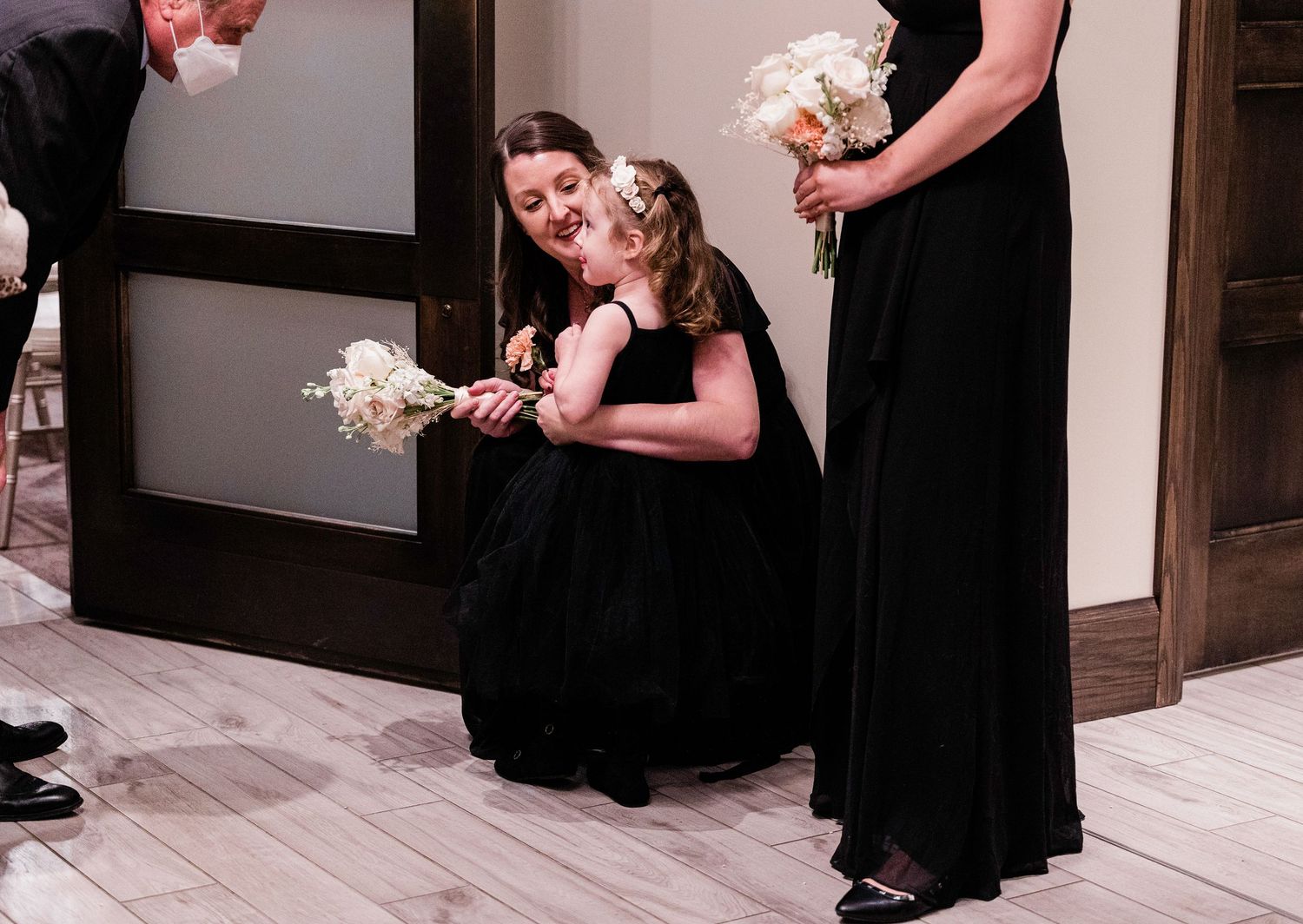 Wedding party members in formal attire standing in line during ceremony preparations.