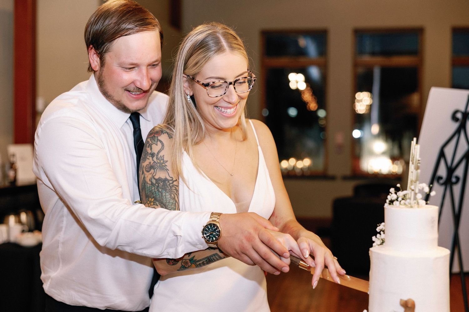 Wedding reception guests enjoying a celebratory moment at an indoor venue.