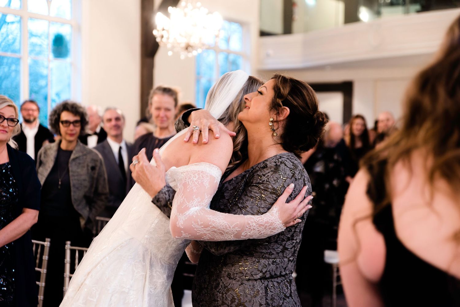 Wedding guests celebrating and dancing during reception festivities.