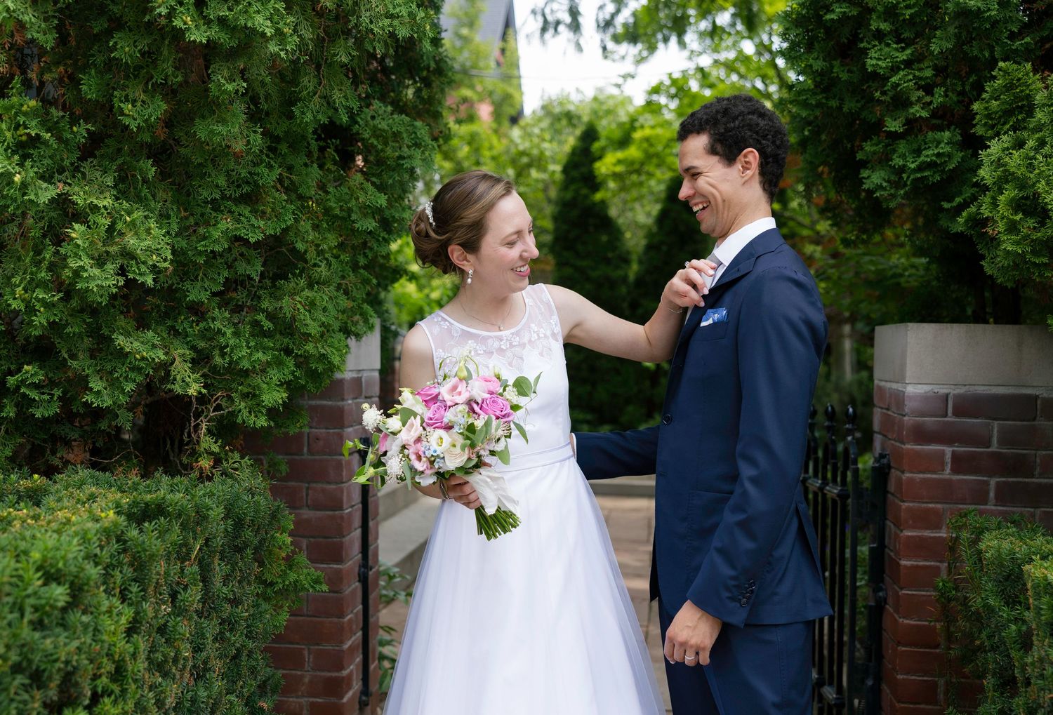 Romantic wedding portraits captured along garden pathway with natural greenery.