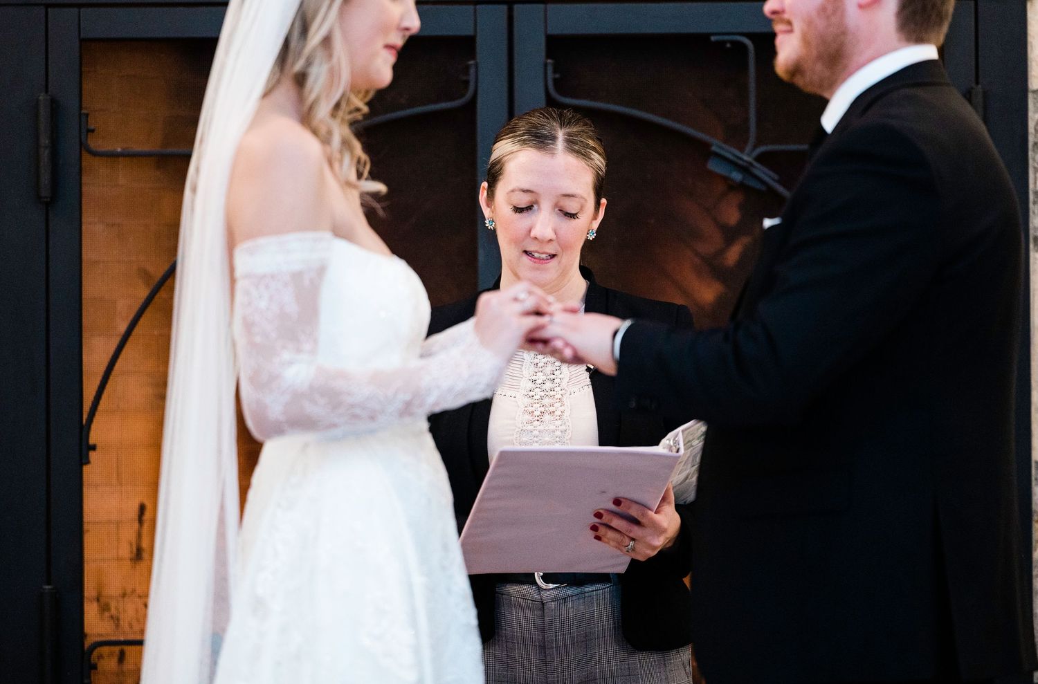 Wedding ceremony moment showing couple exchanging vows at the altar.