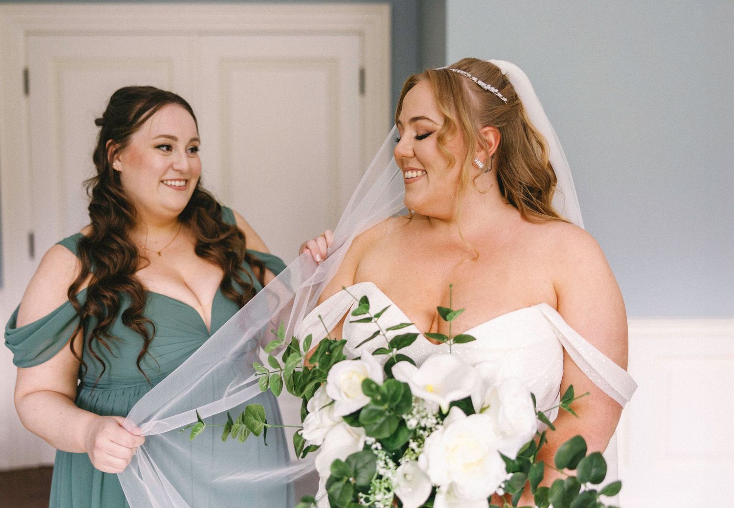 Wedding party members in sage green and white dresses prepare for the ceremony.