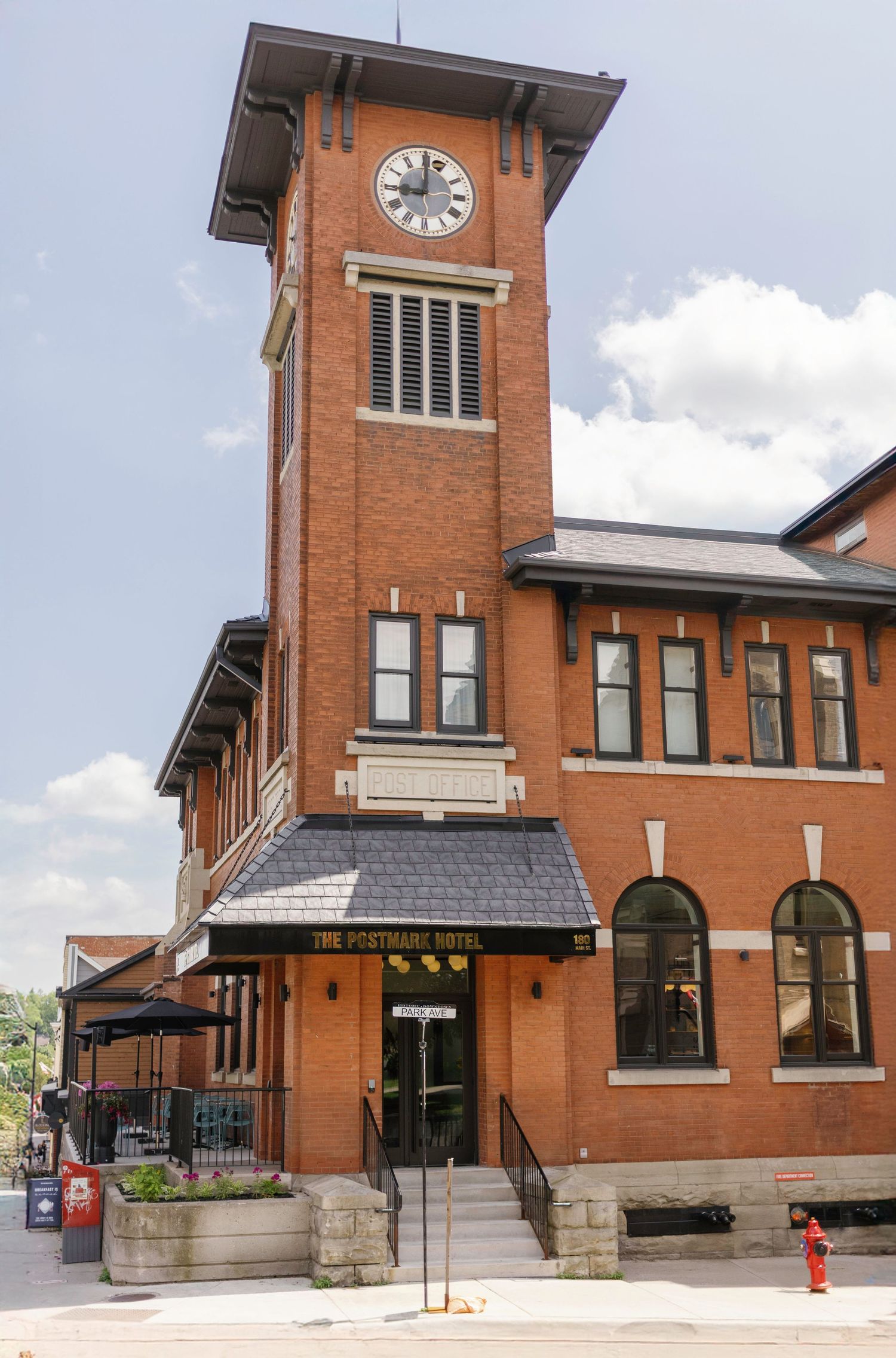 Historic brick building with clock tower and arched windows in classic architectural style.