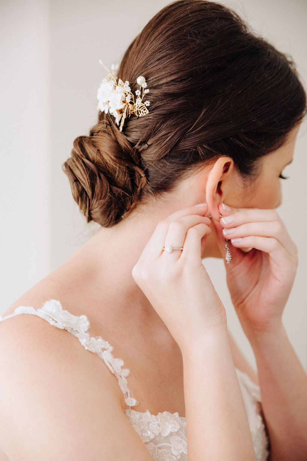 Close-up sequence showing delicate bridal hair accessories and lace dress details from different angles.