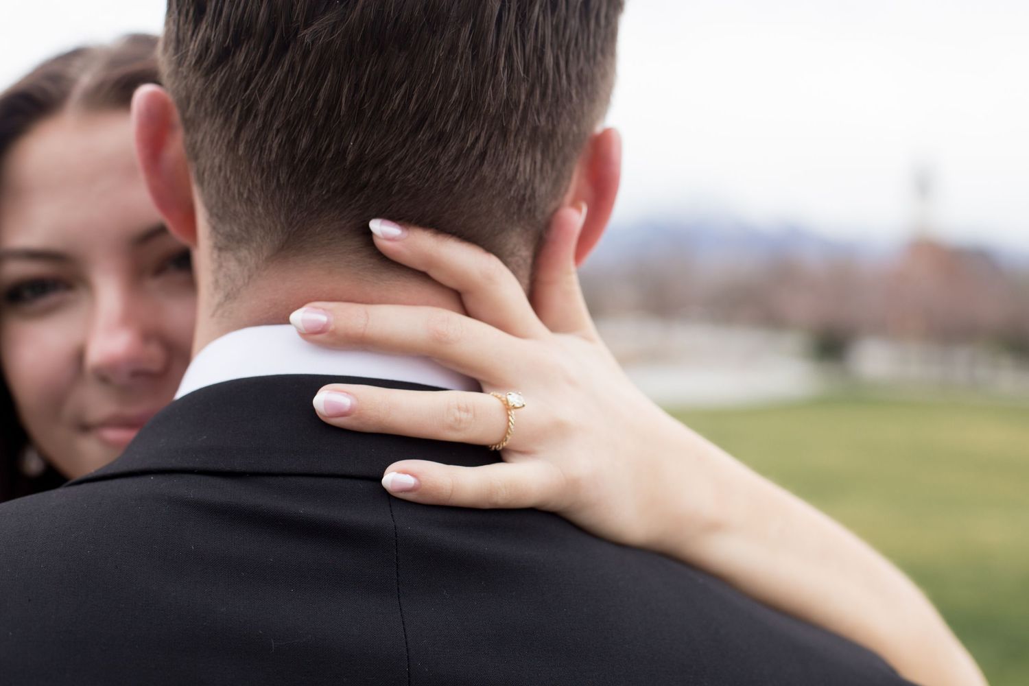 A close-up shot captures an intimate embrace between a couple.