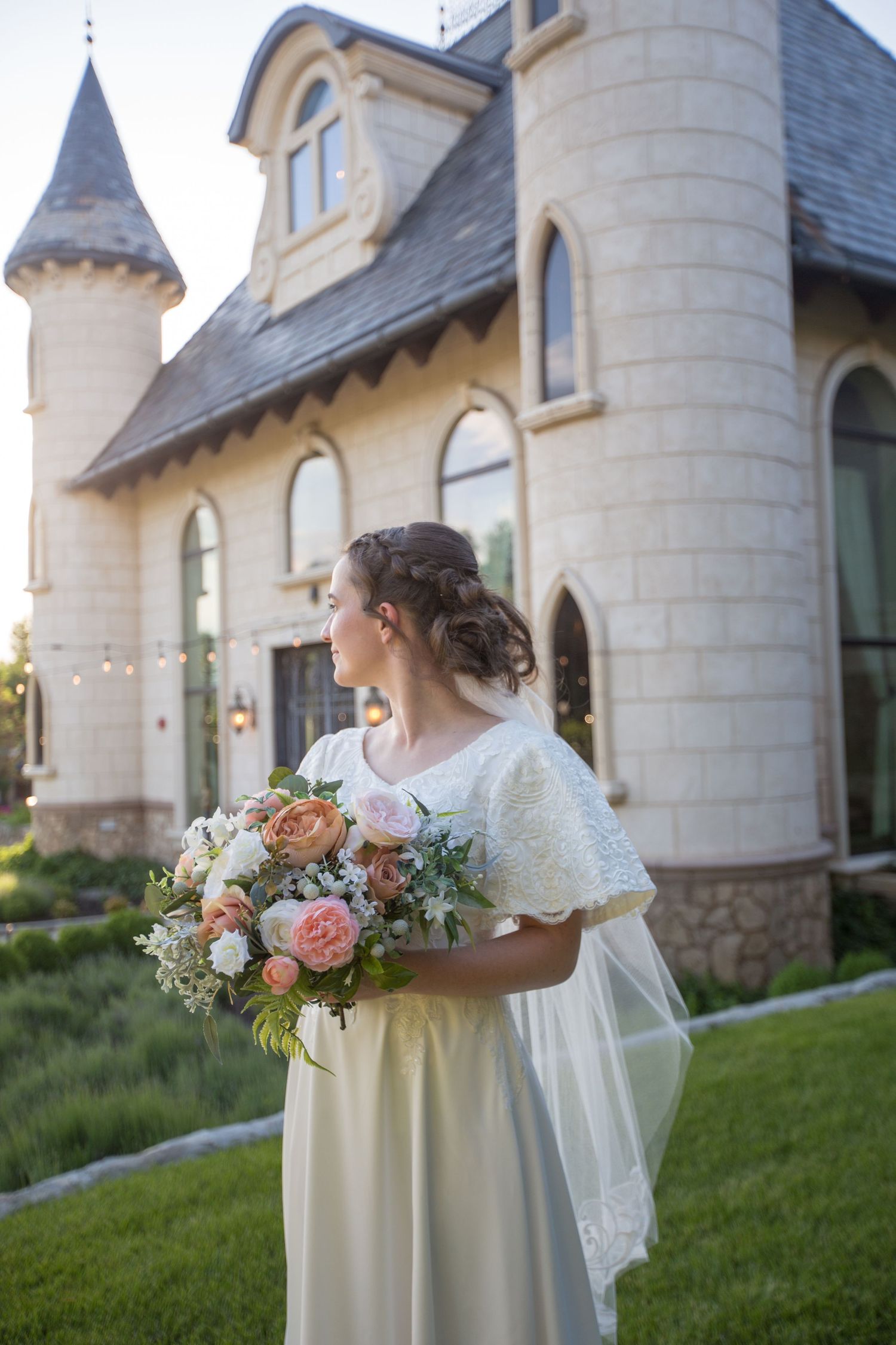 Romantic bridal portrait showcasing peach and pink bouquet against Gothic chapel architecture.