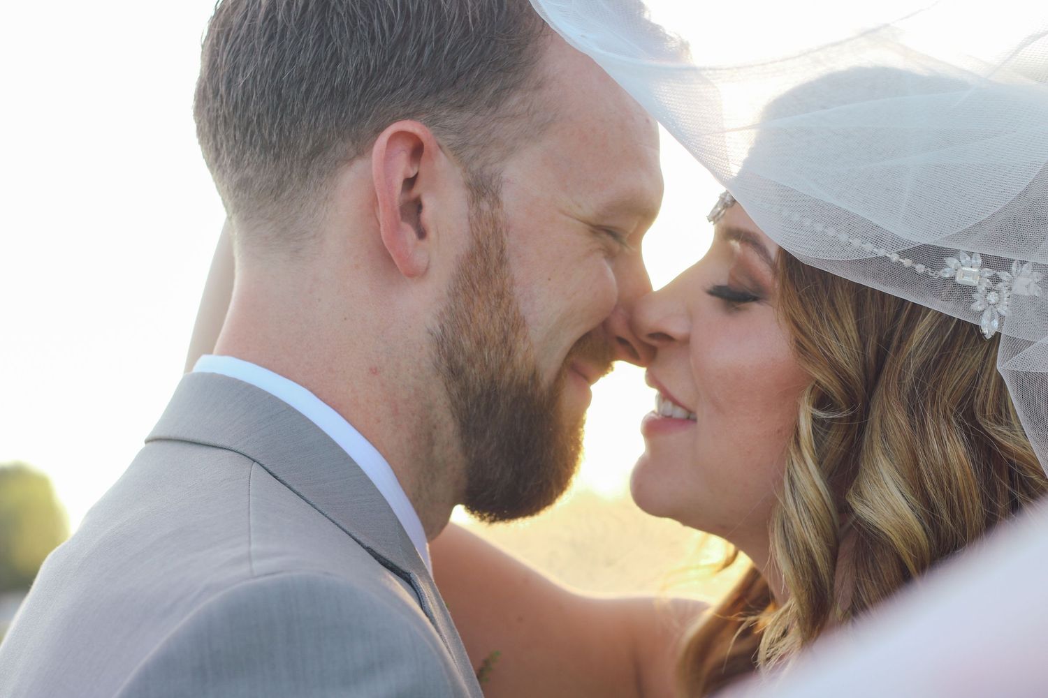 A romantic sunset wedding portrait session with soft golden lighting.