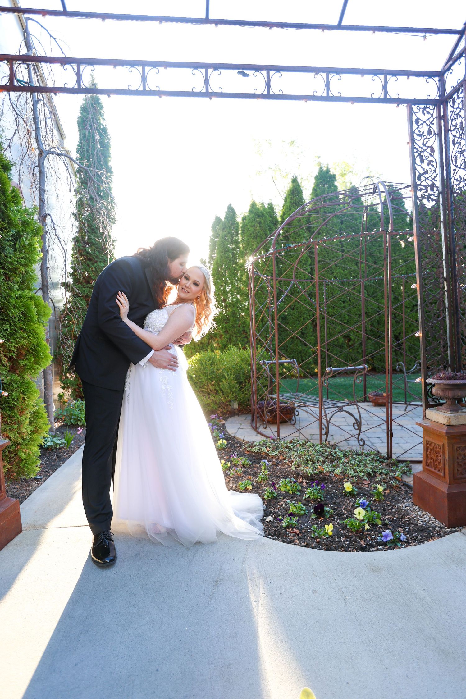 Intimate wedding couple moments captured under a white canopy structure.