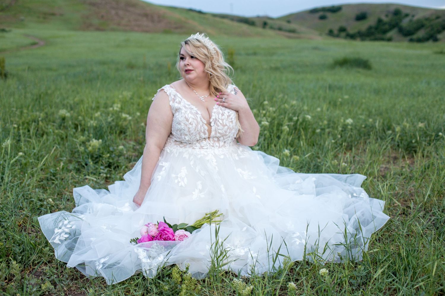 Beautiful bridal photography session in a scenic green hillside setting.
