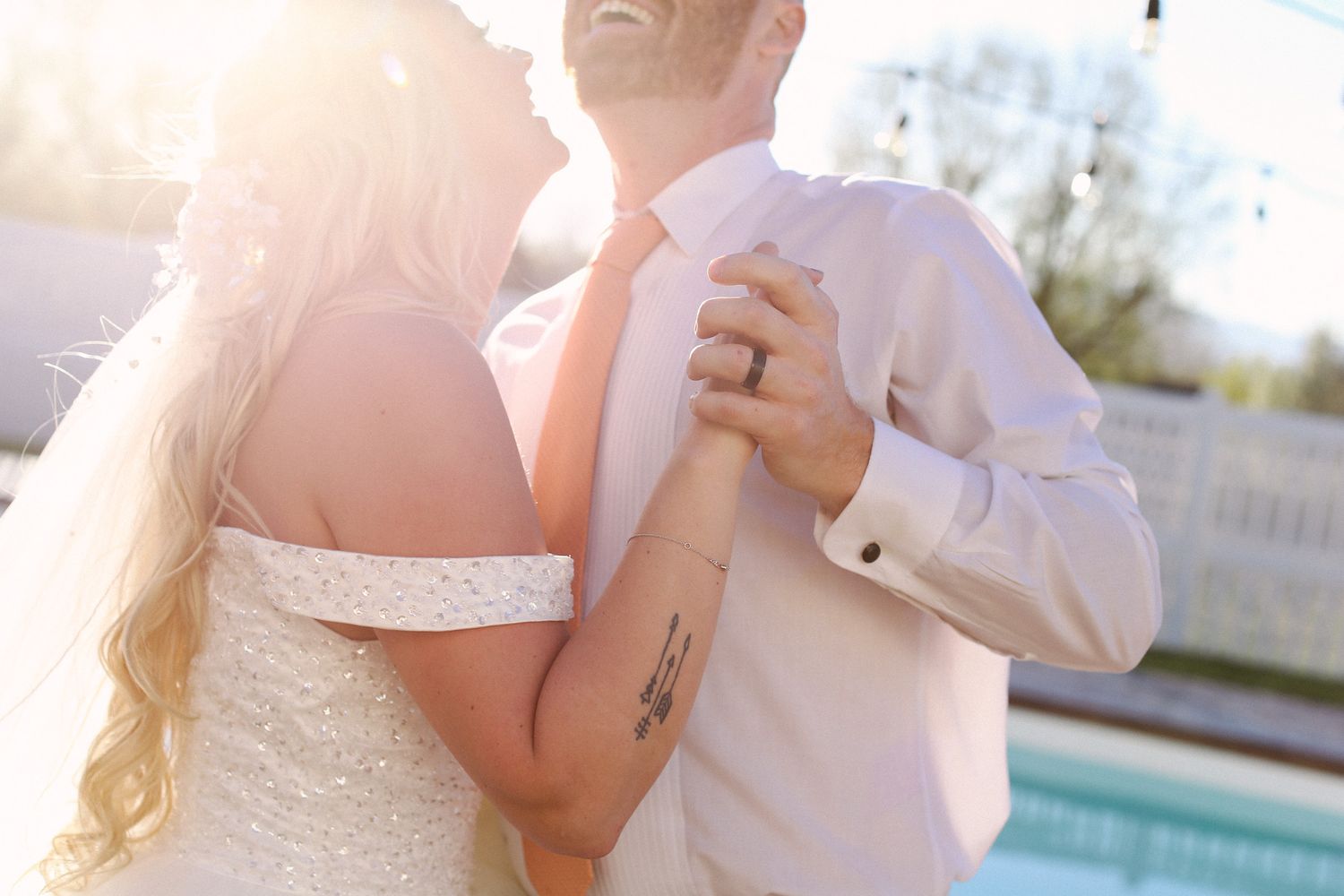 Sun-drenched romantic moment by a pool with soft golden lighting.