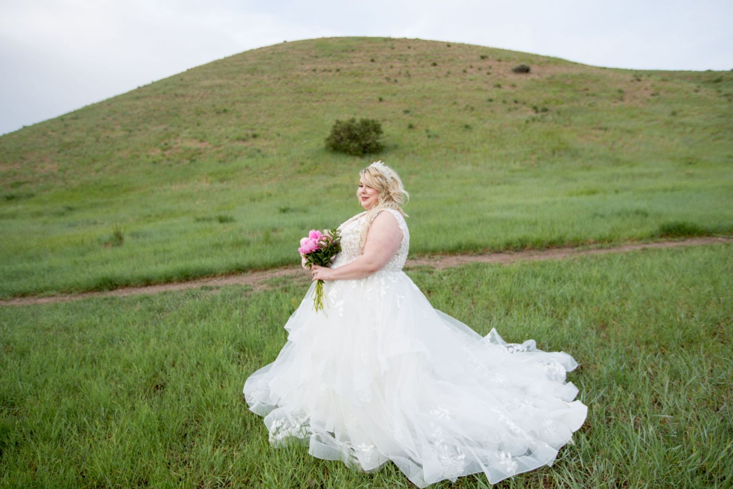 Sweeping landscape view of bridal portraits in natural outdoor setting.