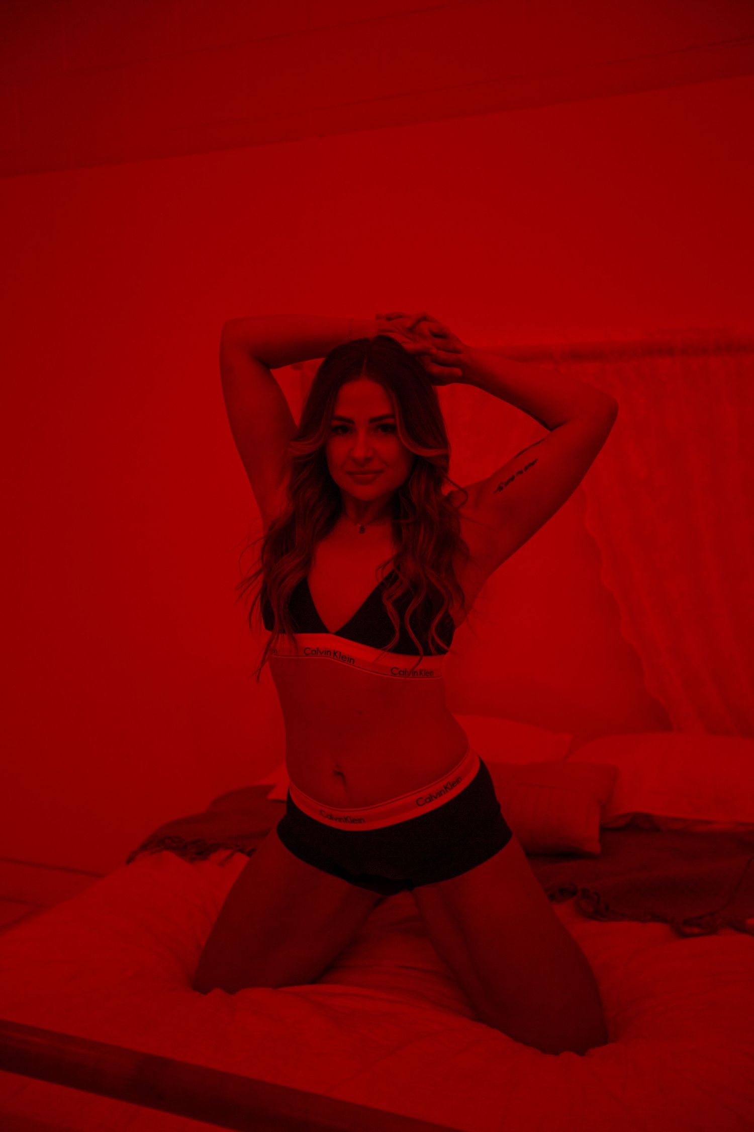 Artistic boudoir sequence with deep red lighting effects.