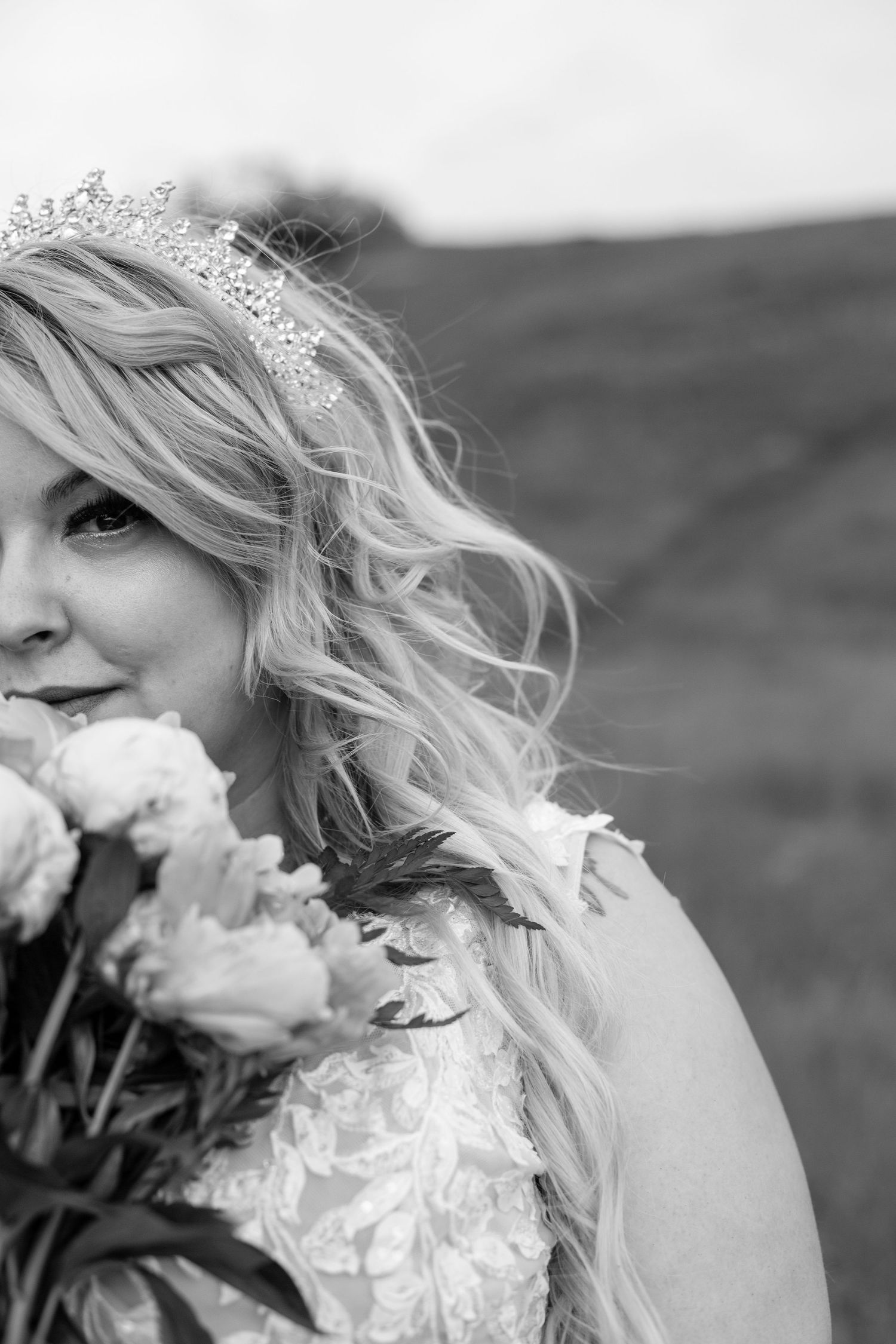 Black and white portrait with delicate lace details and floral bouquet.
