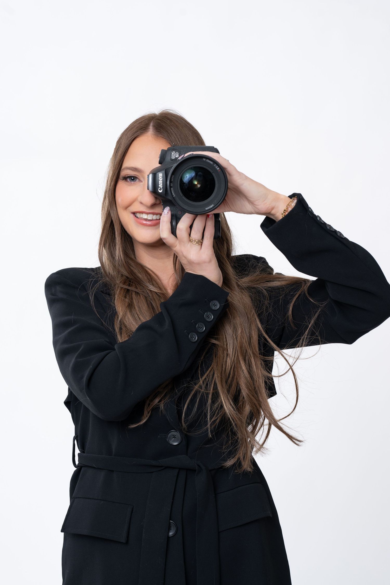 Creative portrait series of photographer holding camera in various poses against white backdrop.