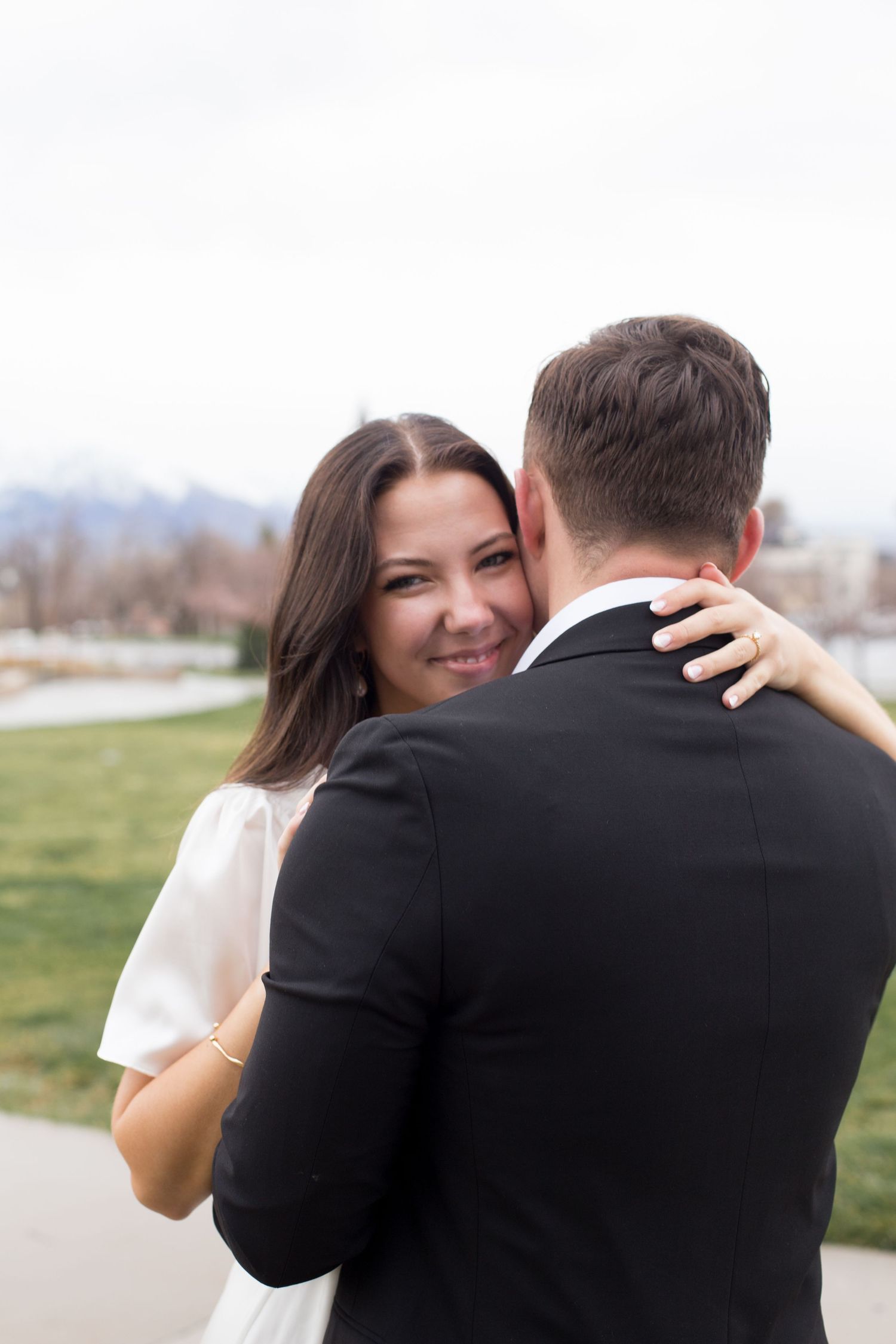 A joyful couple shares a candid moment in their wedding attire.