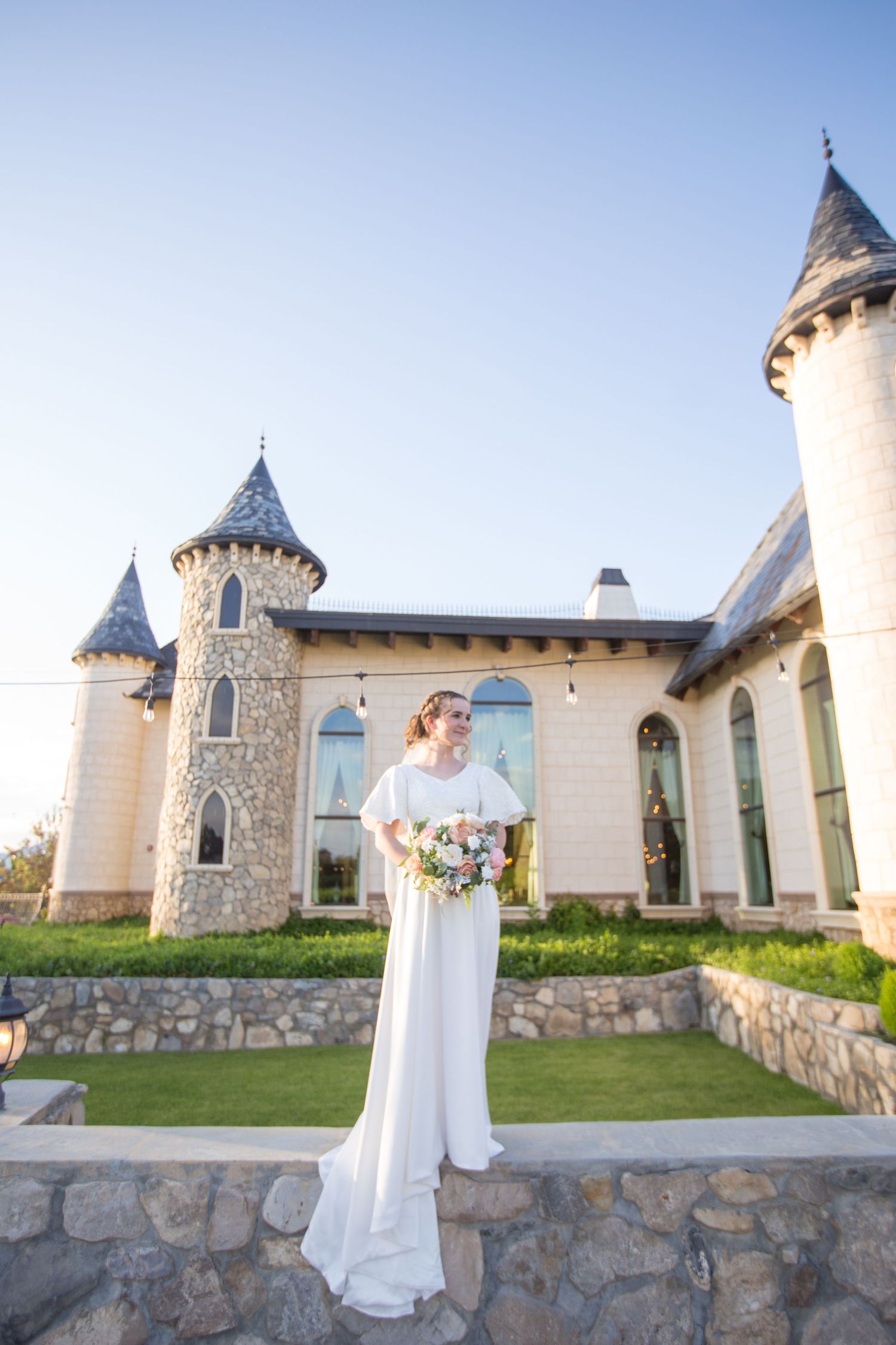 Castle-inspired venue with stone walls and turret features against blue sky.