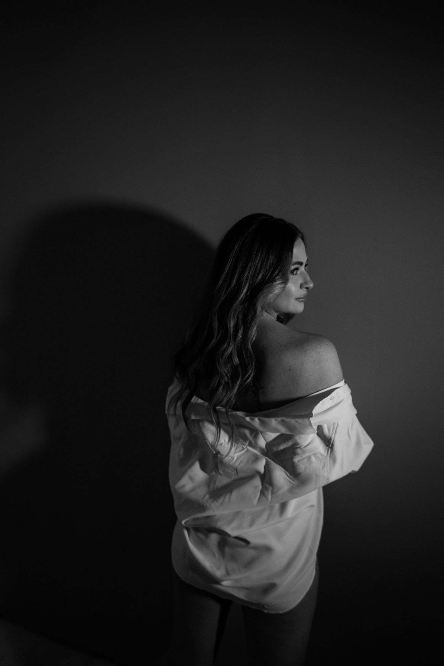 Dramatic black and white portrait series with white shirt.