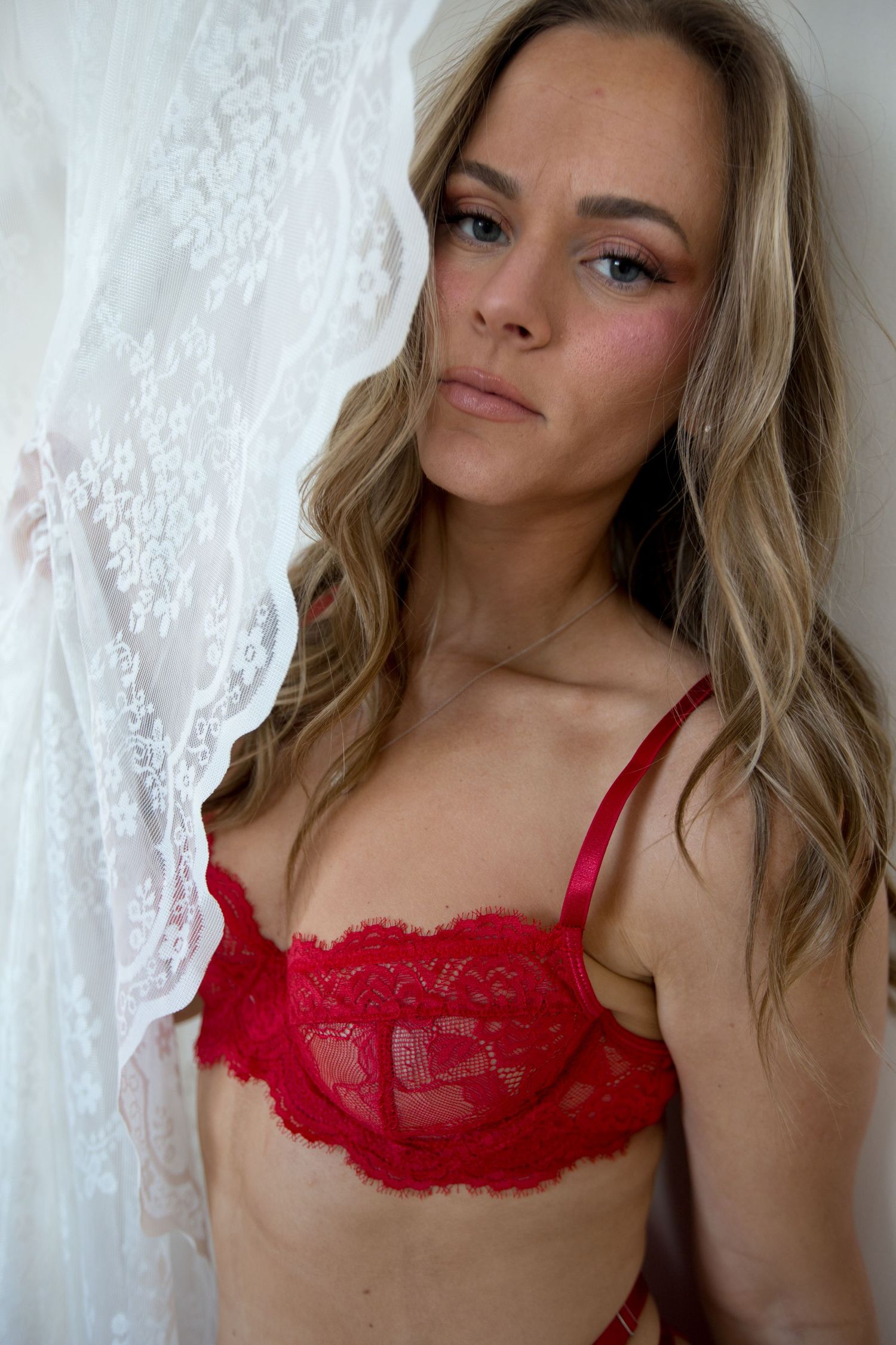 Portrait series featuring red lace lingerie against white backdrop.