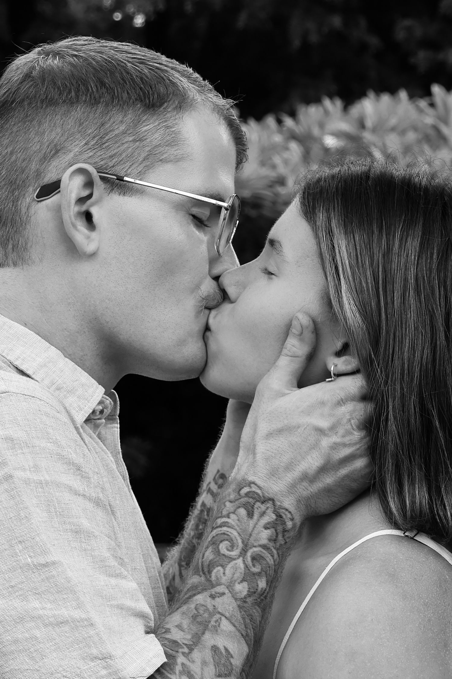 A romantic series of black and white photos showing a couple sharing intimate kisses and tender moments.