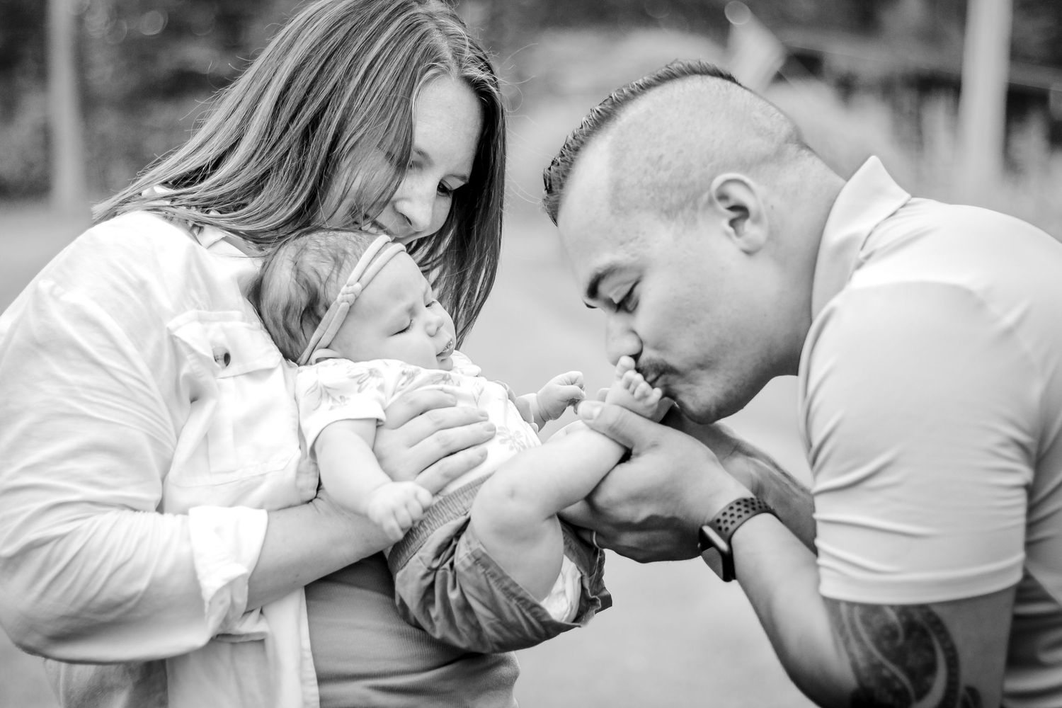 A sequence of black and white photos showing a couple kissing in different romantic poses at Delafield home session
