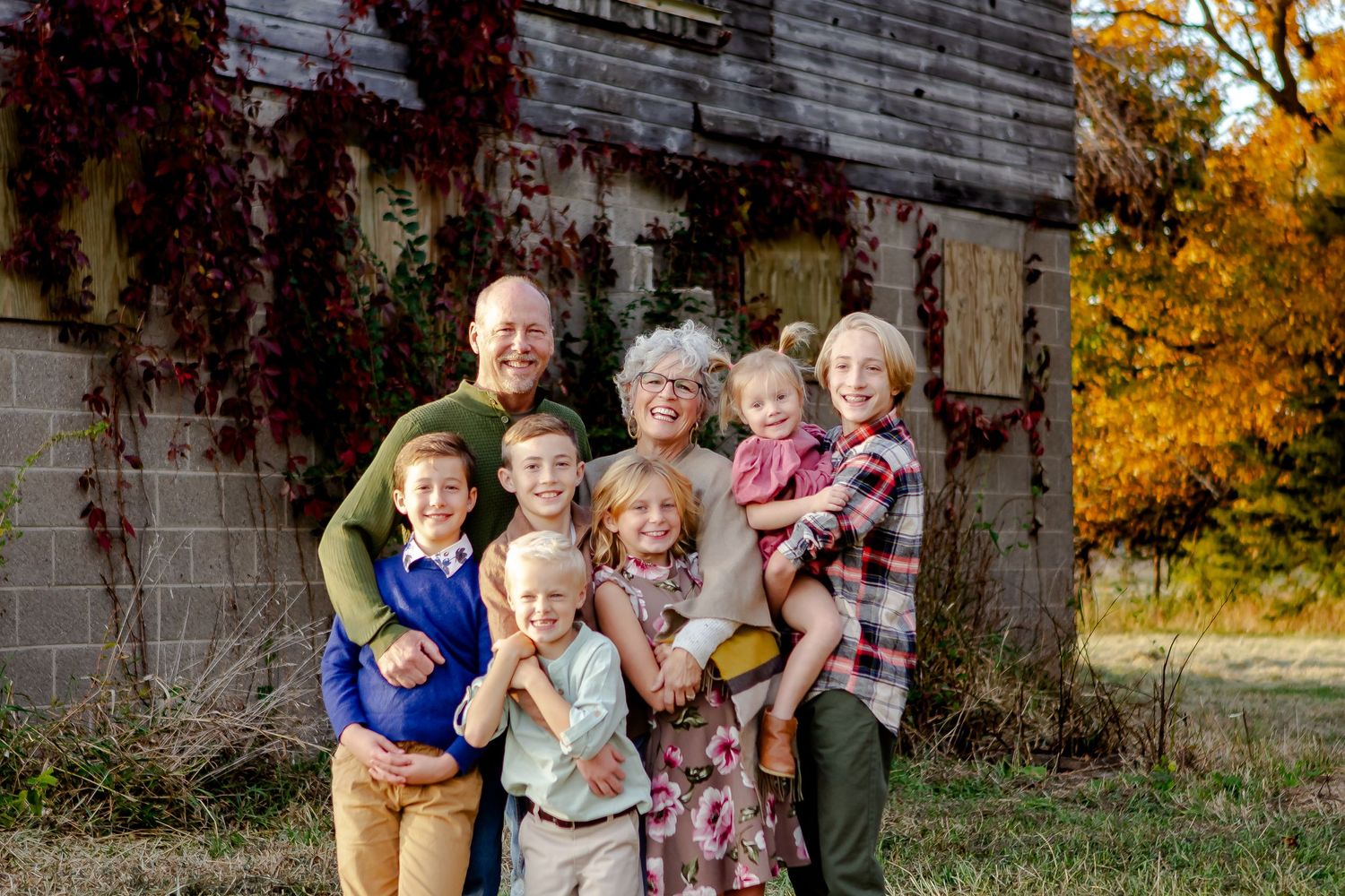 Grandparents share smiles with grandkids during fall photo session in Oconomowoc