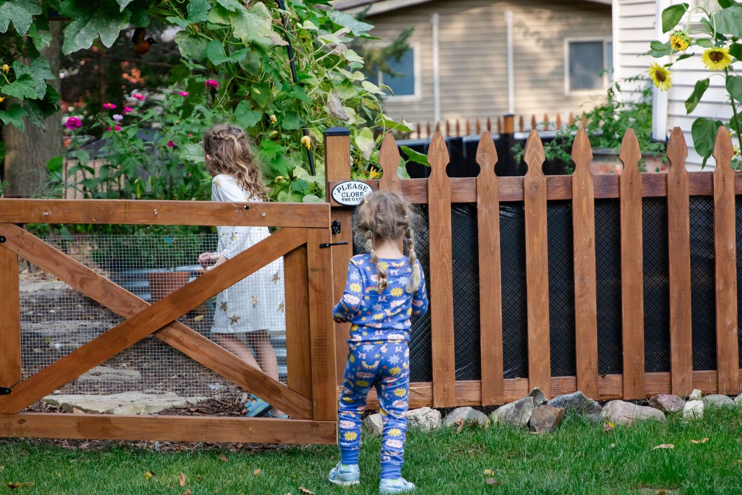 A sequence of photos shows someone in blue pants walking along a wooden fence in a backyard garden setting at Delafield home session