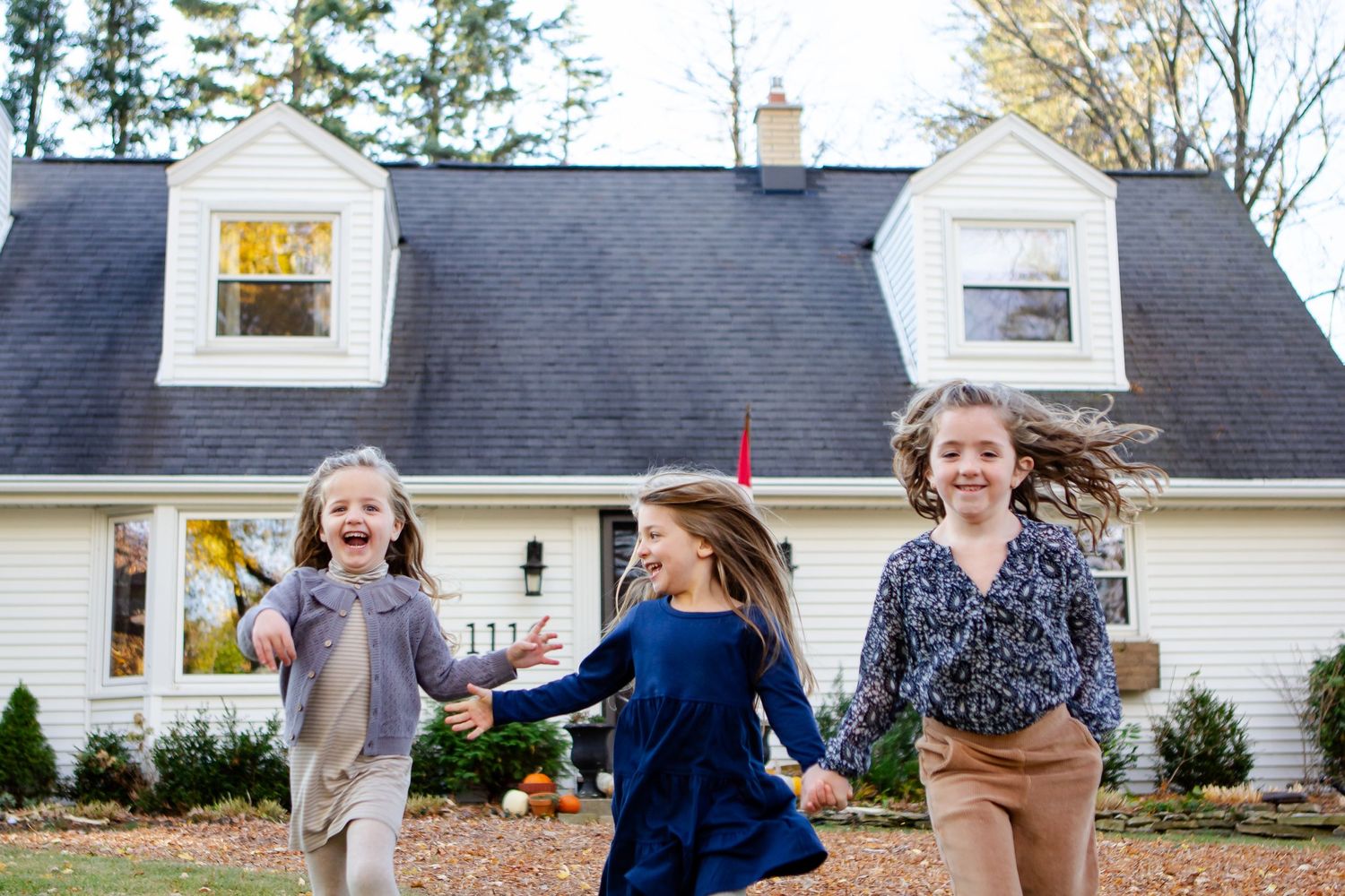 Sisters run outdoors during Delafield family session
