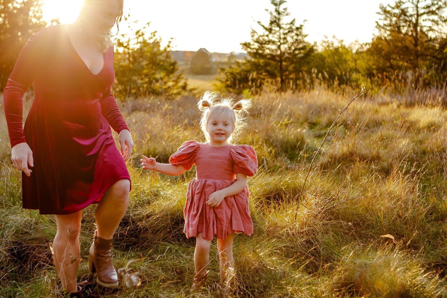 Little girl runs through field with her mom during fall photo session in Oconomowoc