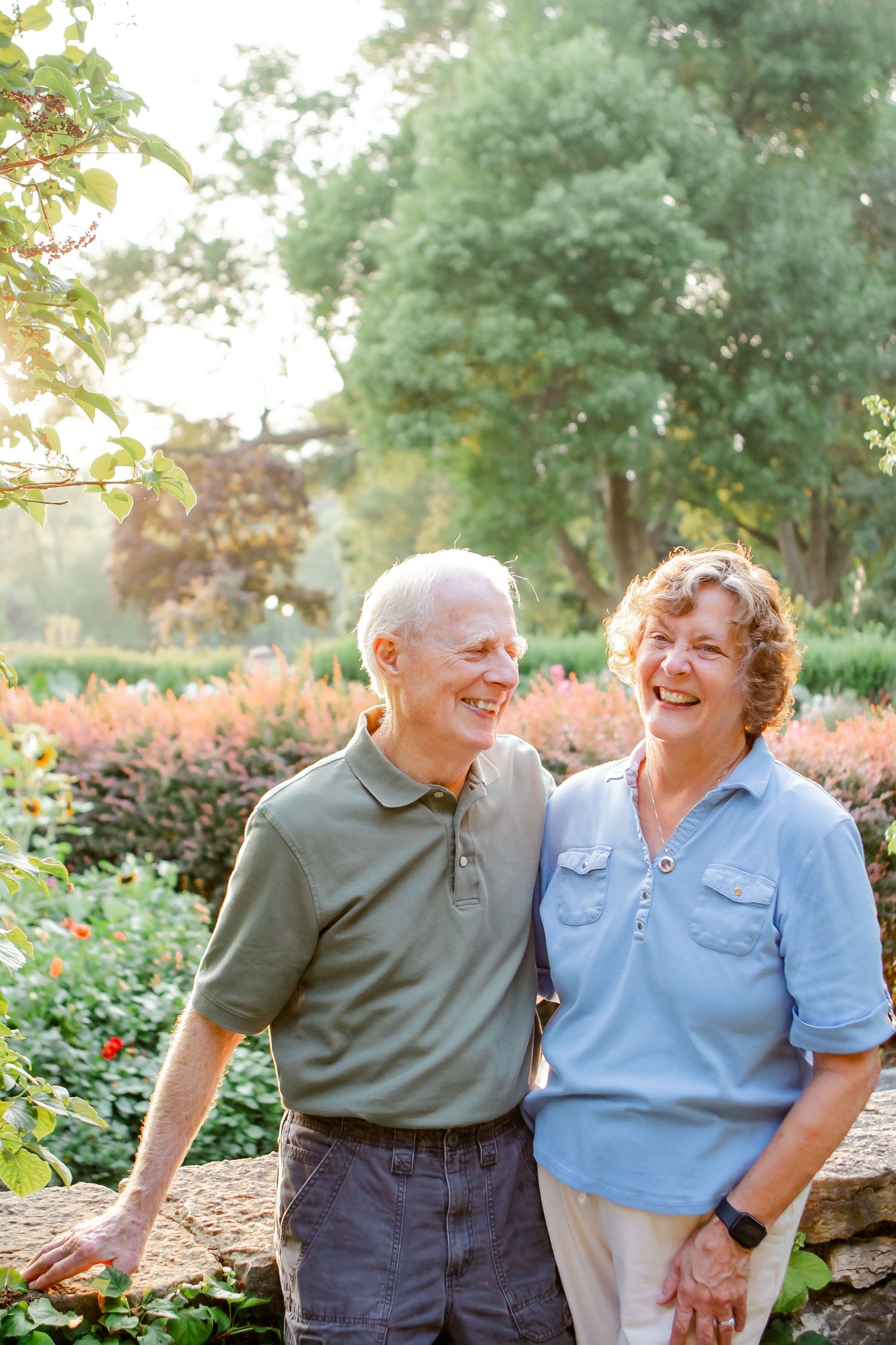 Senior couple sharing loving moments in a lush garden setting.