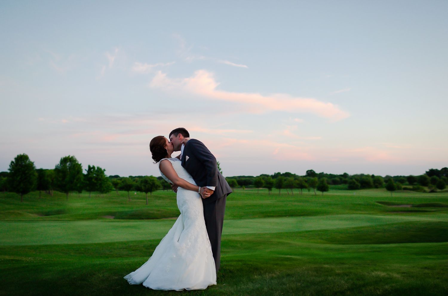 Romantic sunset moment captured on a sprawling golf course.