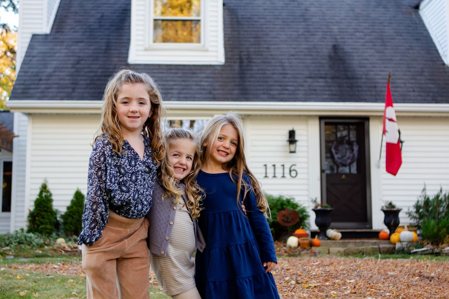 Three sisters pose together during fall photo session in Delafield