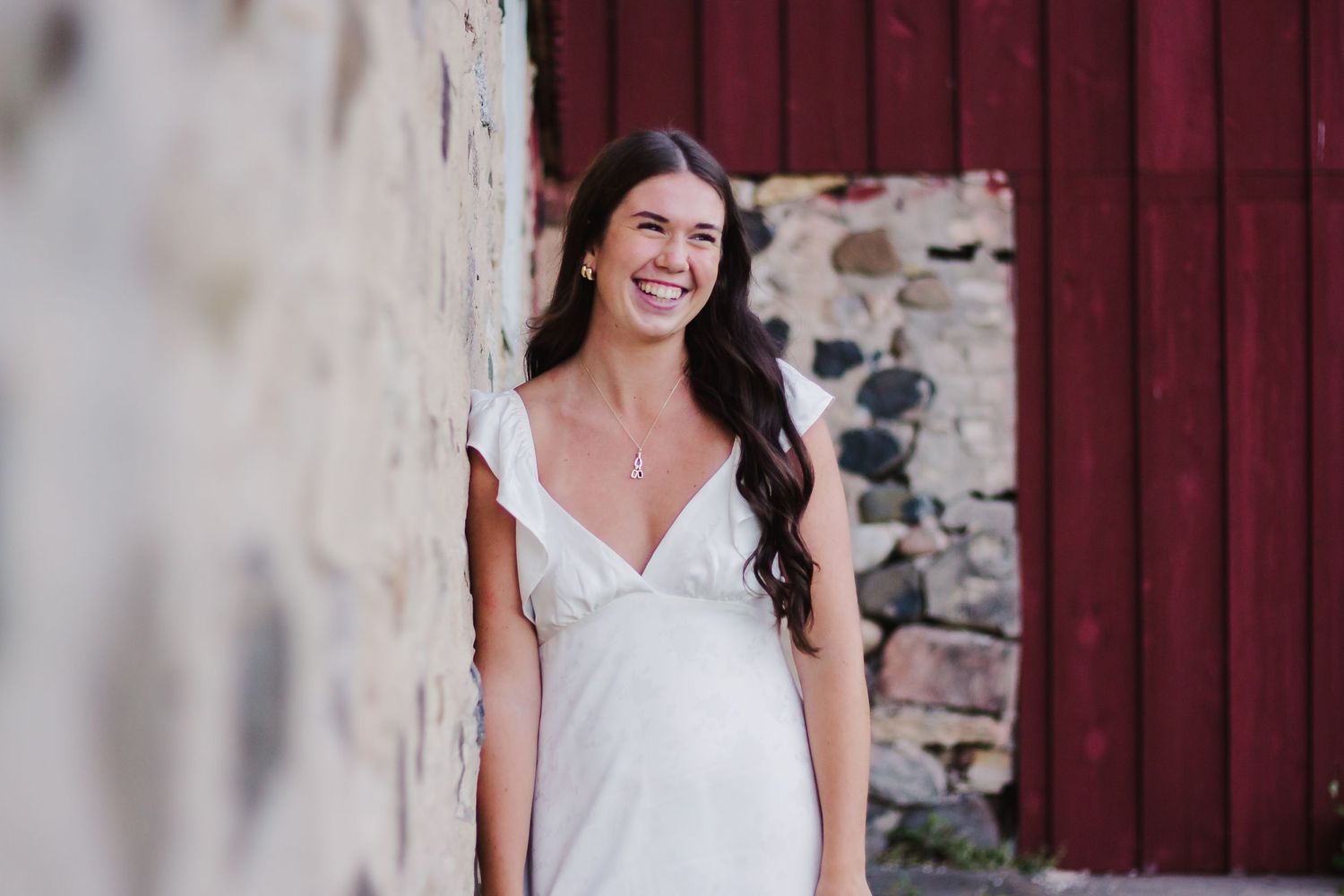 Vintage-style portrait against weathered brick wall and burgundy painted wood.