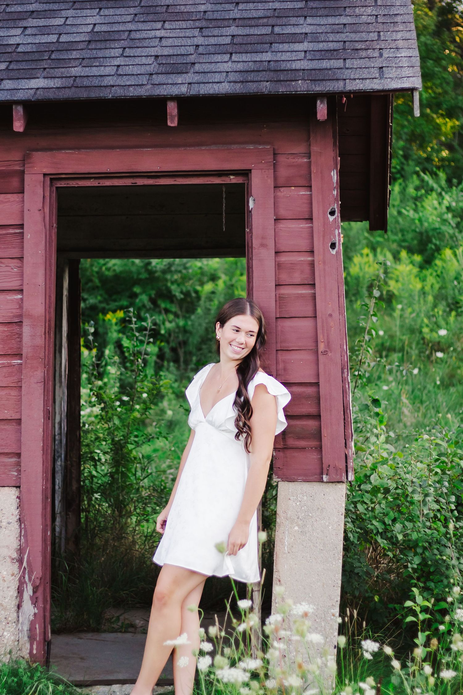 Rustic red wooden structure provides vintage backdrop for outdoor photography.
