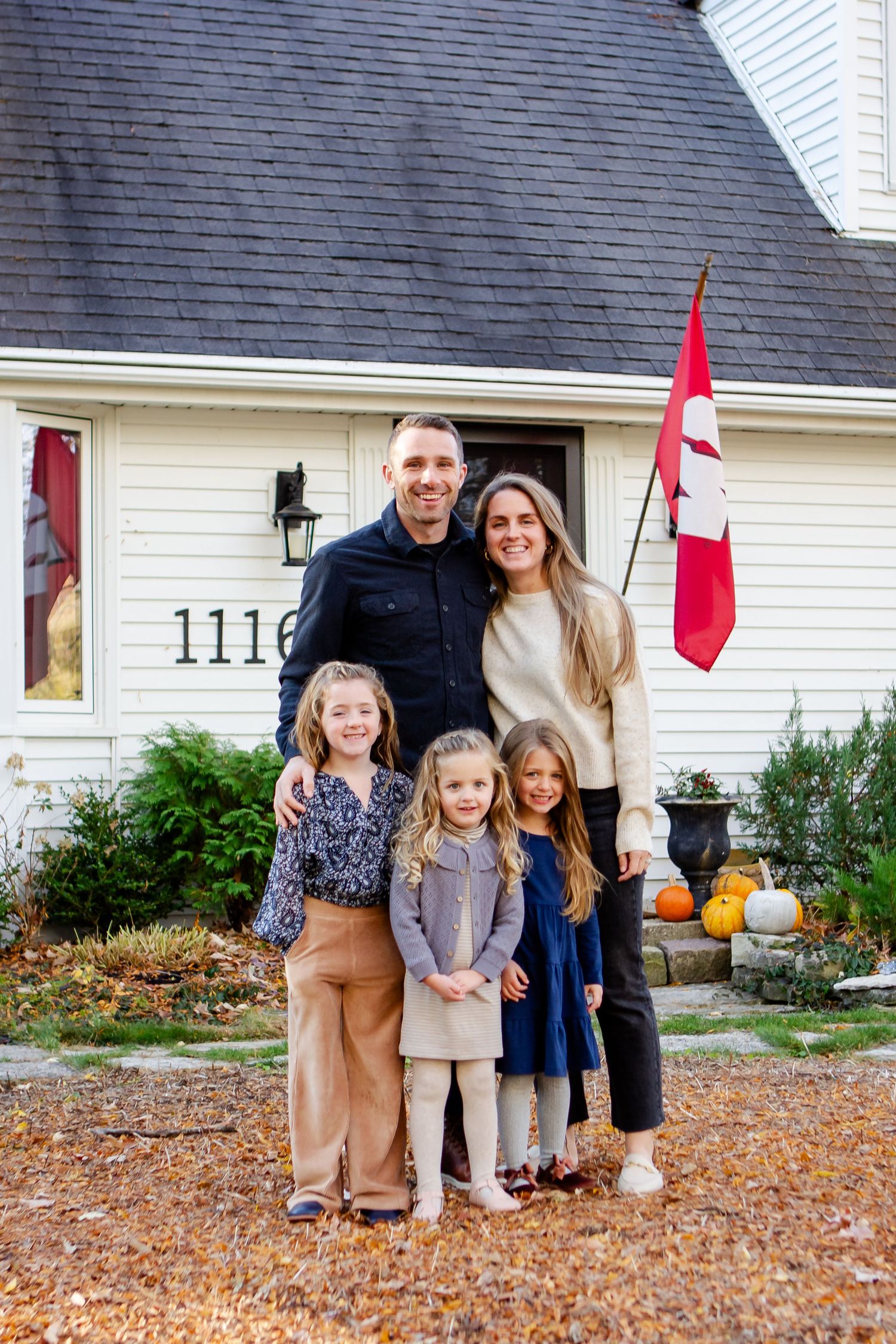 Nelson family poses outside of home during fall photo session in Delafield