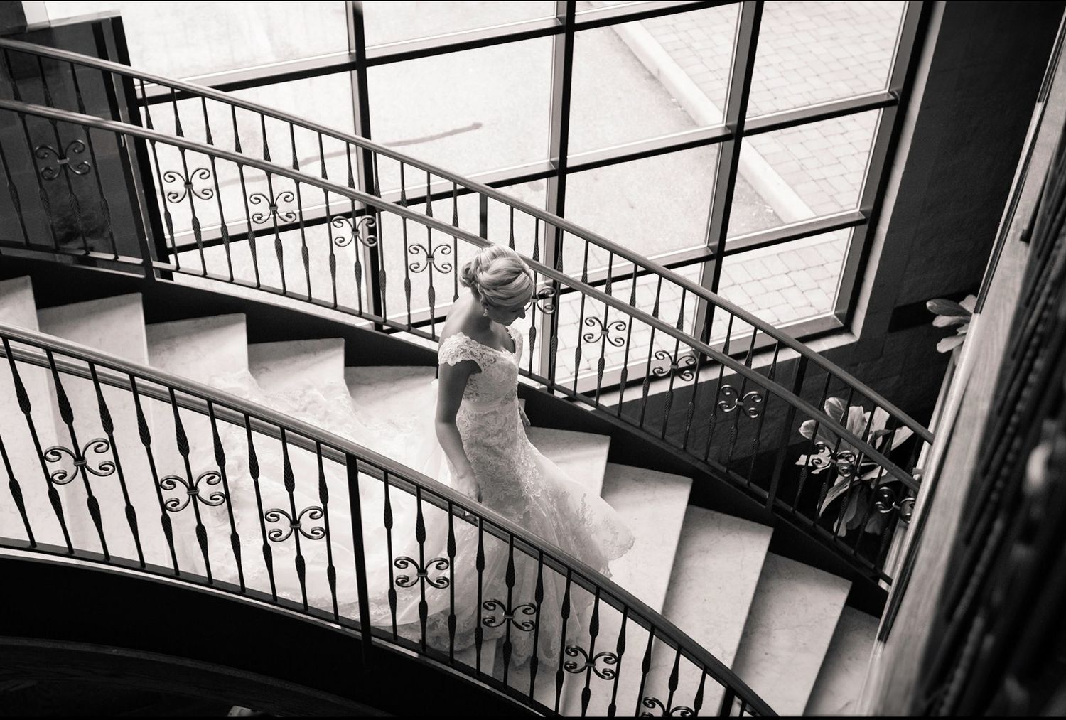 Black and white staircase photos showcase flowing wedding dress details.