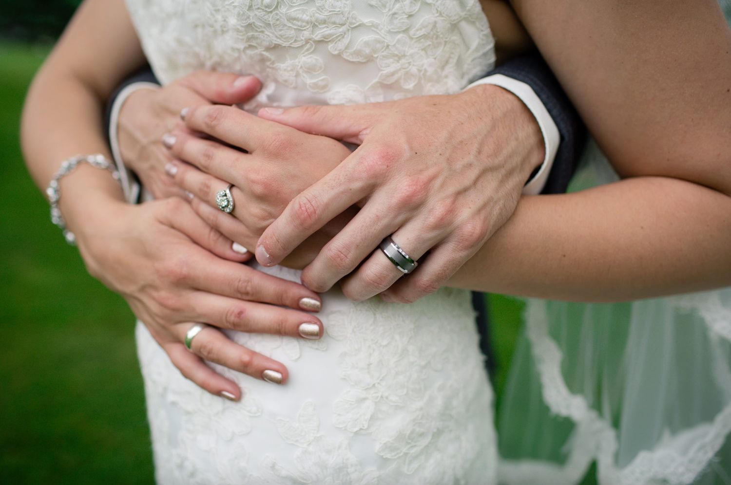 Close-up detail shots of a white lace wedding dress with delicate beading and embellishments by Milwaukee wedding photographer