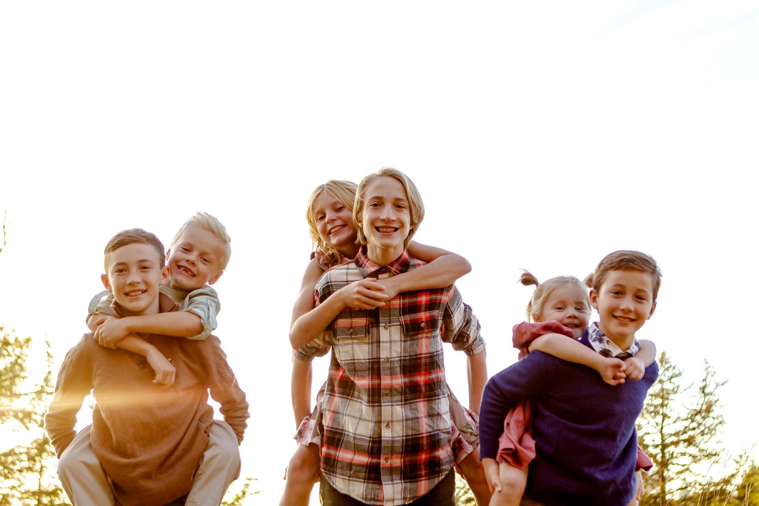 Cousins play and share hugs during fall photo session in Oconomowoc